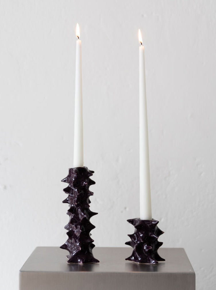 Spiky dark brown candle holder with intricate design and rustic finish