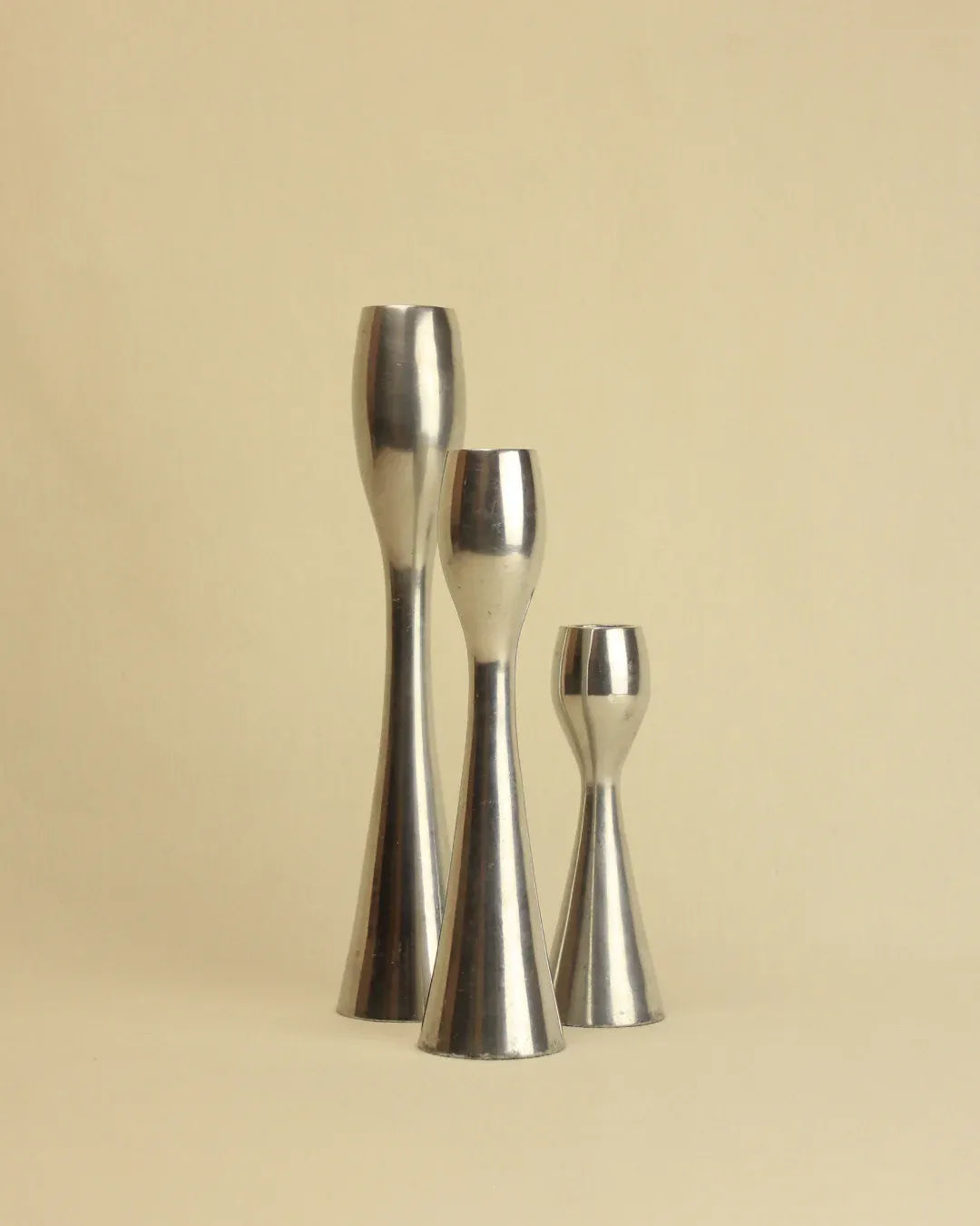 Trio of modern metallic candleholders with sleek and simple design