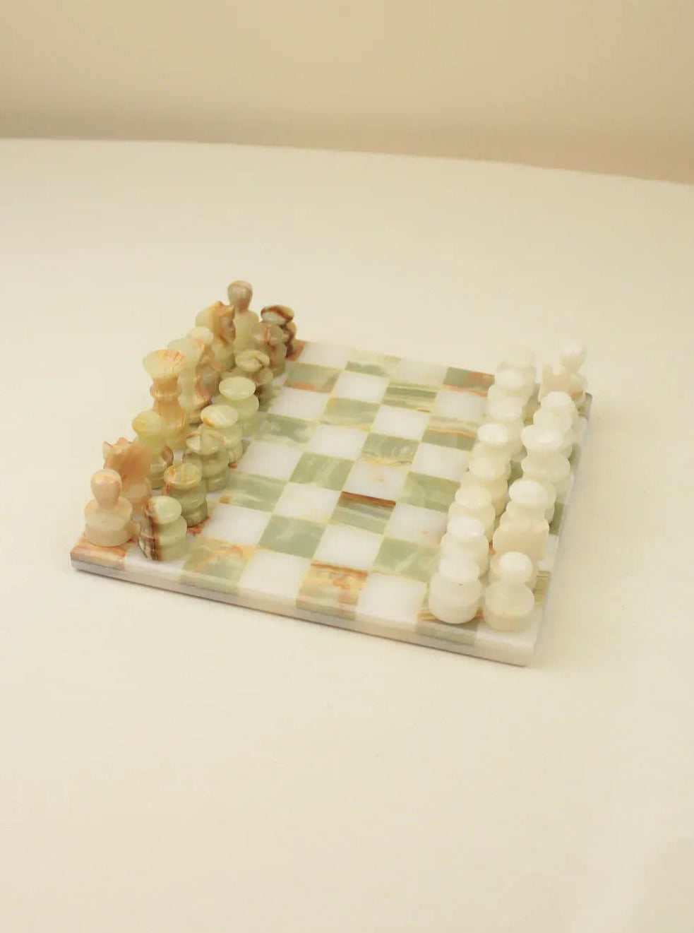 Vintage chessboard in onyx with intricate marble patterns and gold accents