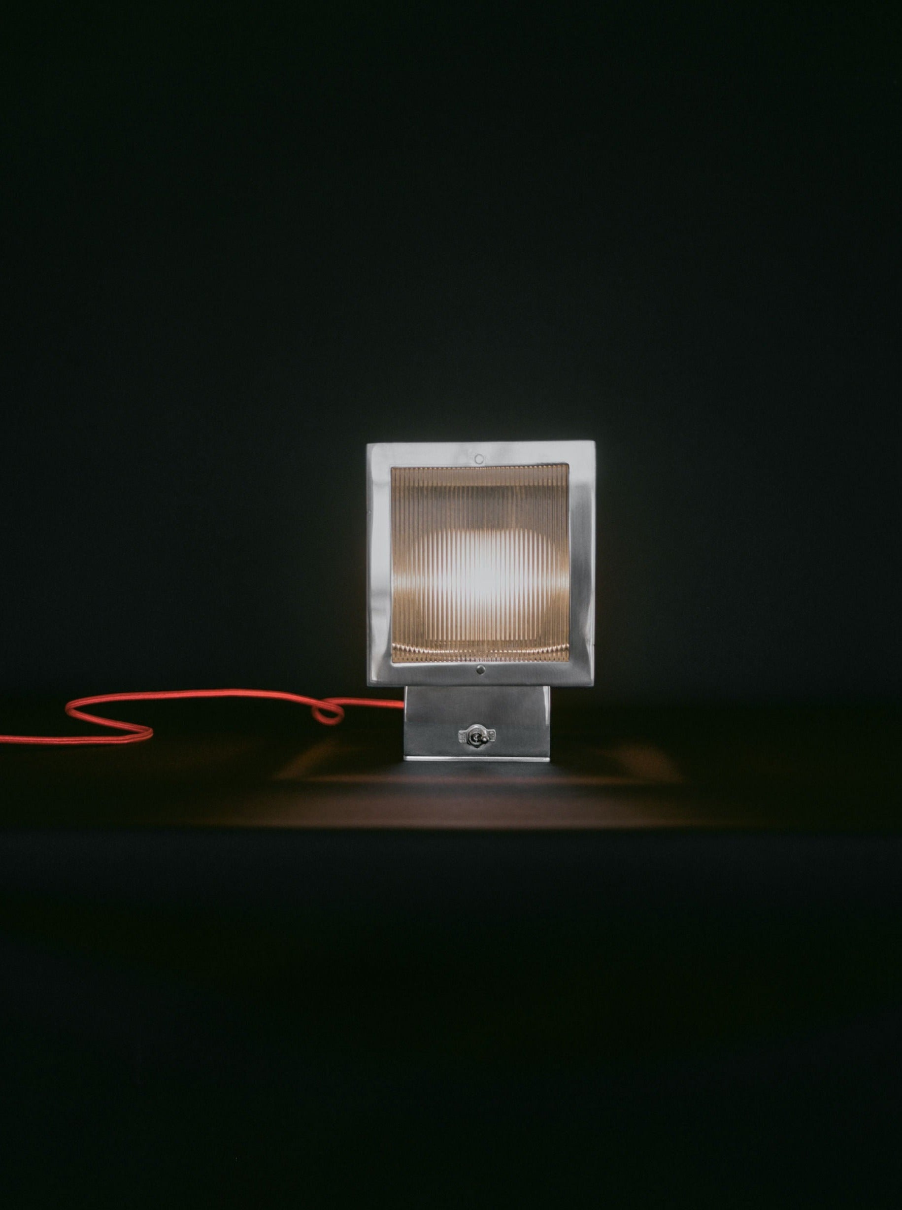 Minimalist table lamp with sleek metal base and curved neck