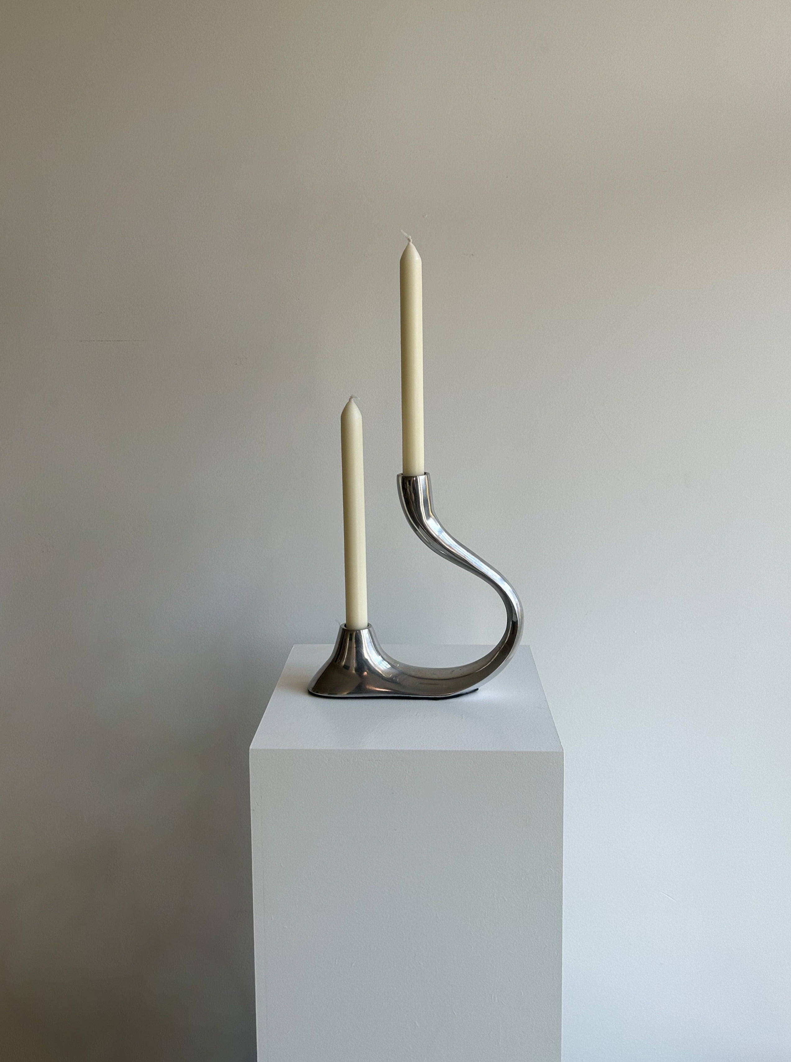 Handcrafted bronze curvy candle holder with intricate detailing and elegant design