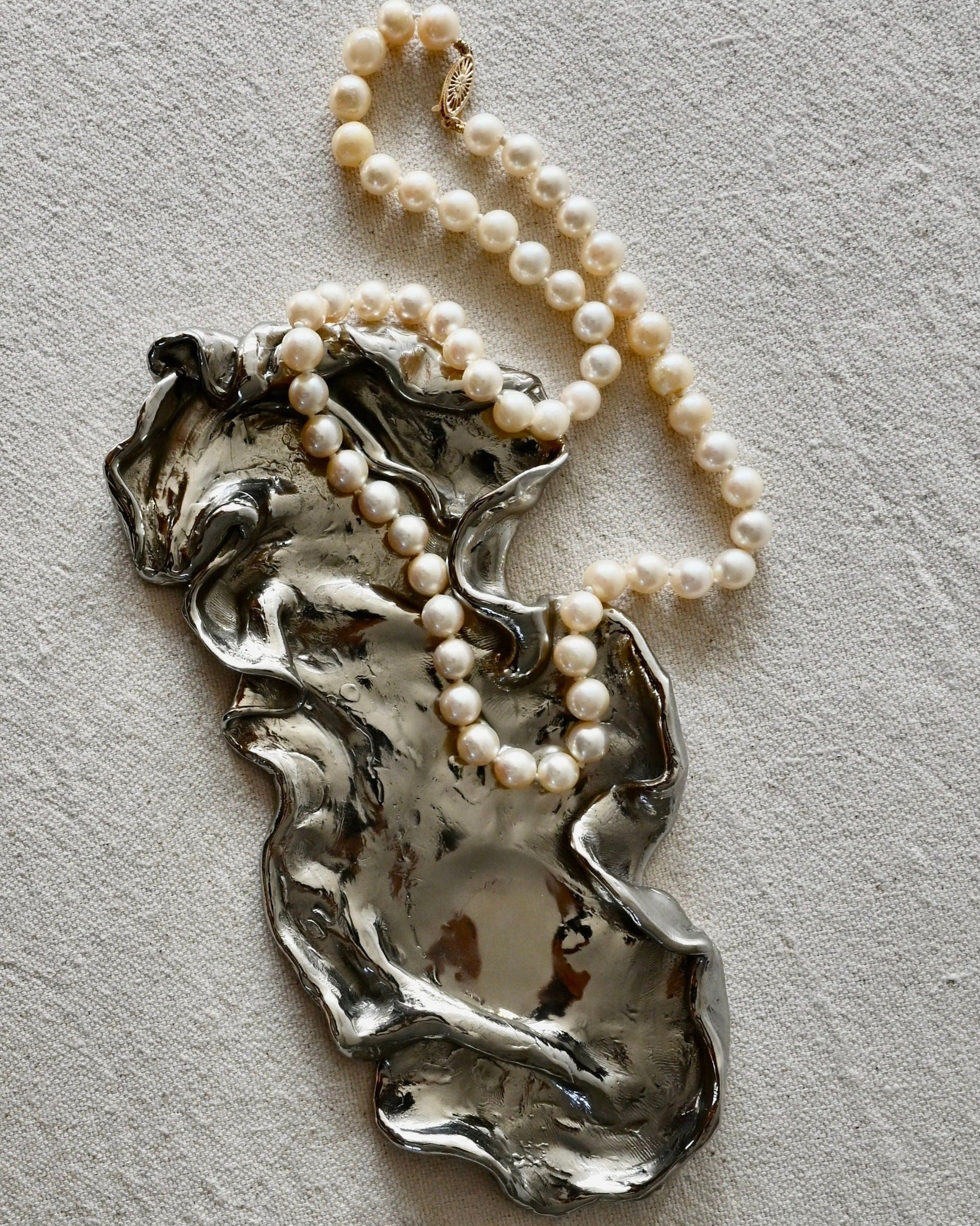 Narcissus Catchall in white marble with gold trim, perfect for organizing jewelry and small accessories