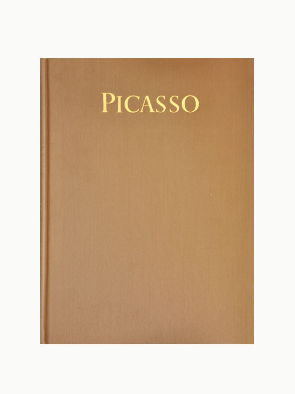A book cover in a plain brown color with the word "Picasso" (Masters of Art) printed in gold at the top center. The background is plain, emphasizing the simplicity and elegance of Maison Plage's design.
