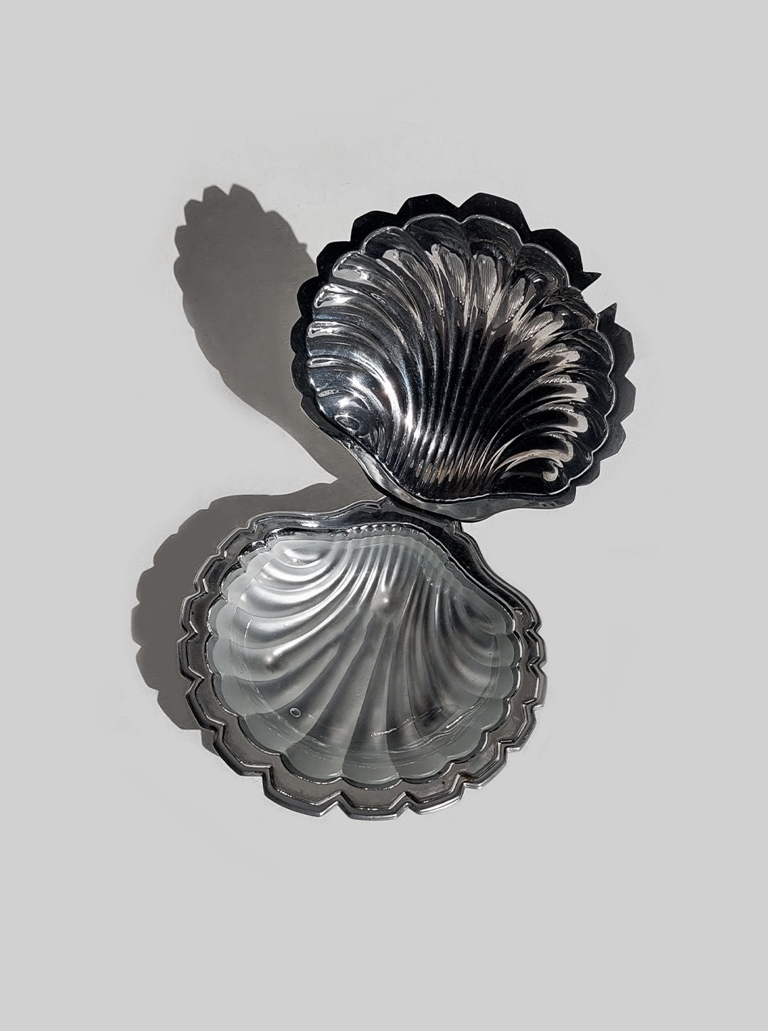 Shell-shaped ceramic butter dish with intricate floral design