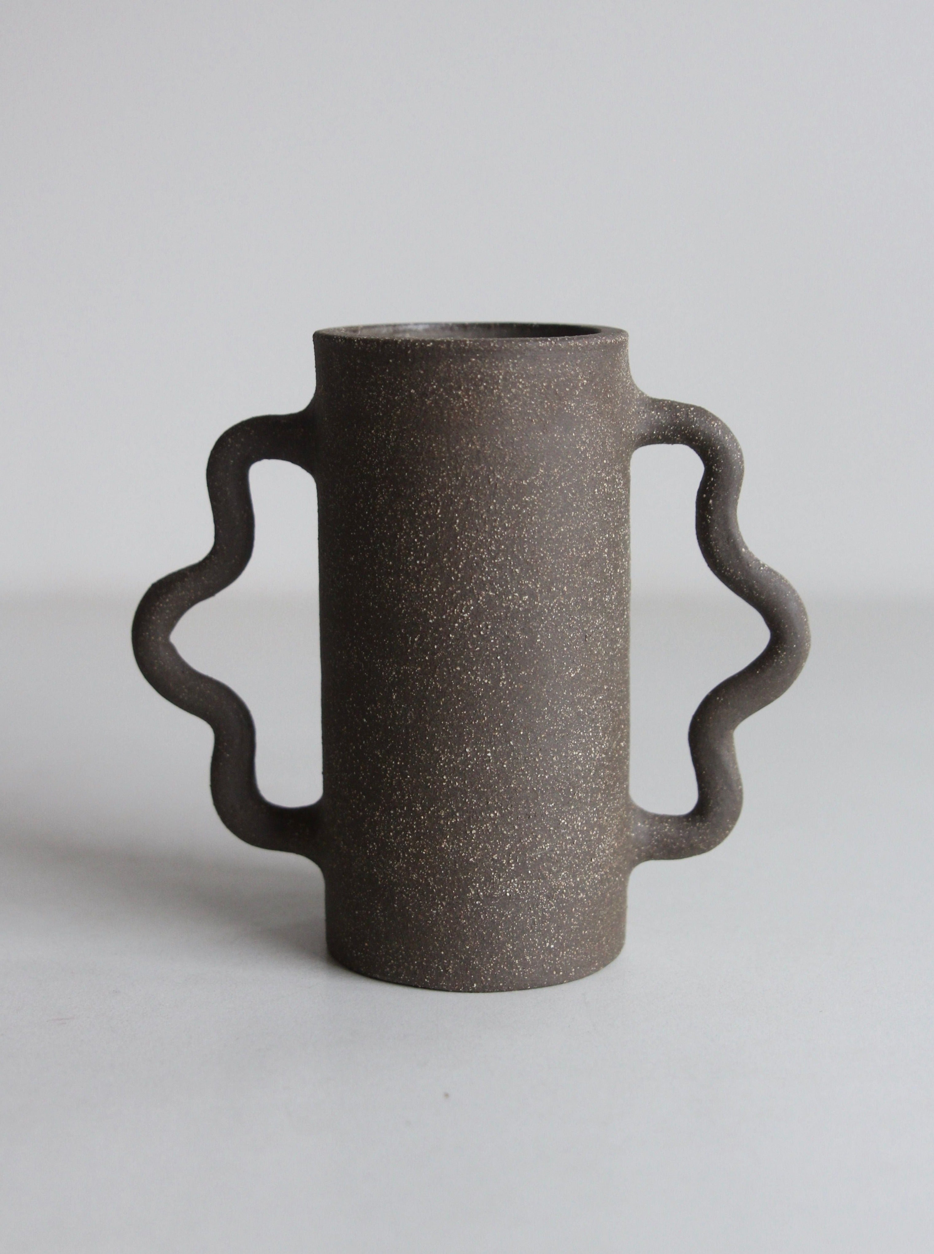 Handcrafted glass curvy bud vase with elegant lines and unique design