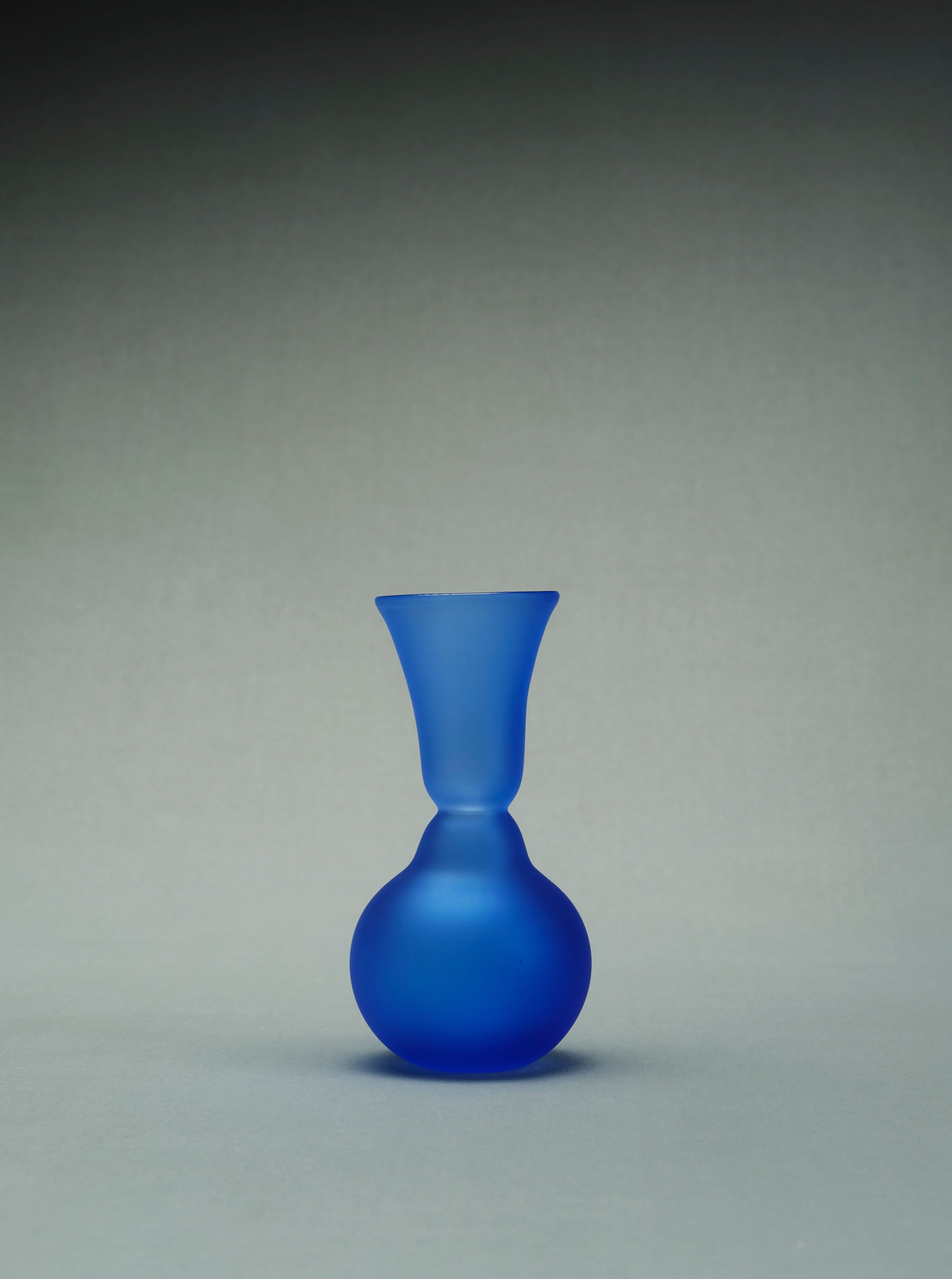 Handcrafted small blue ceramic vase with delicate floral design and glossy finish