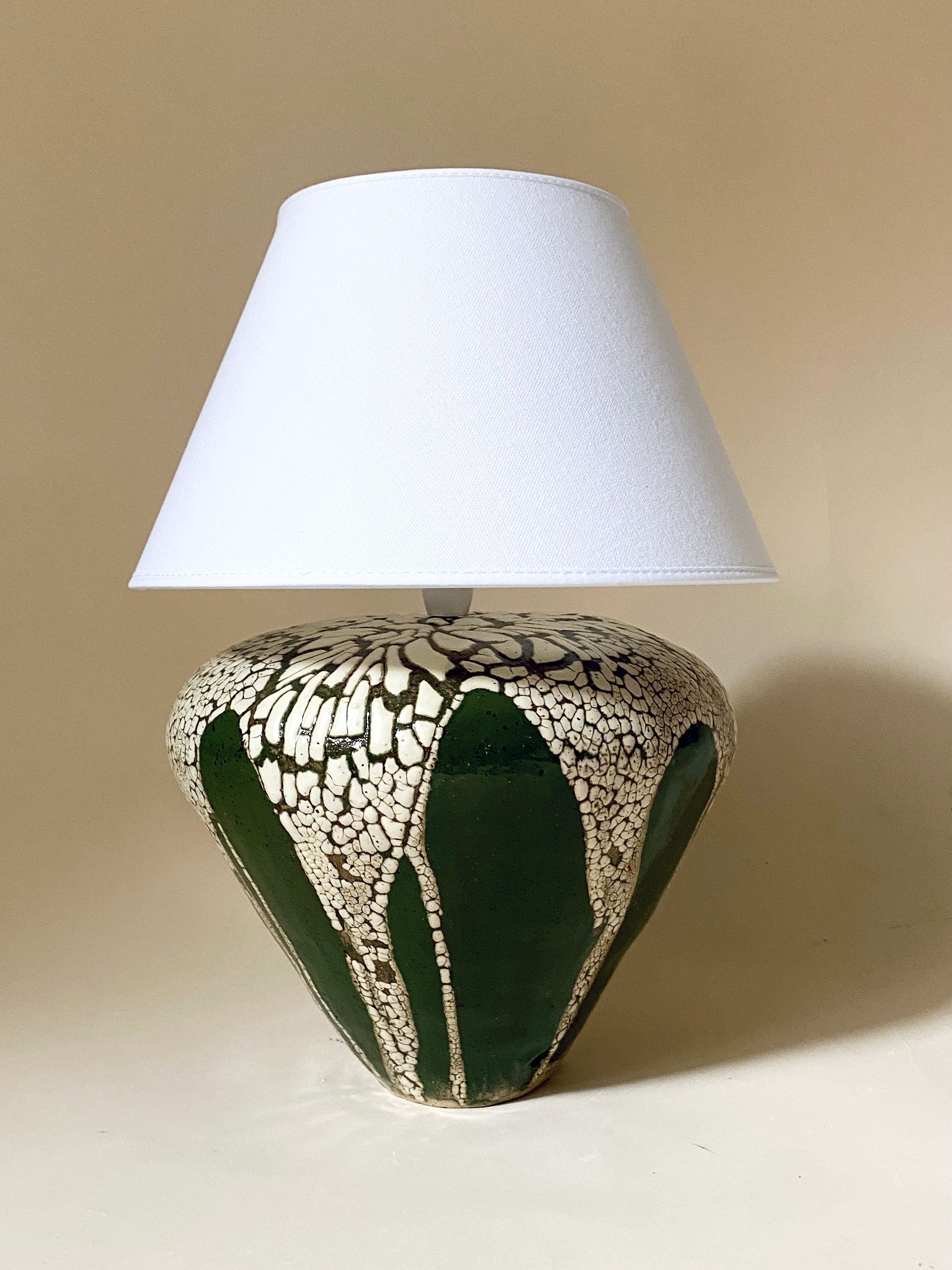A stylish and modern green table lamp, perfect for adding a pop of color to any room decor
