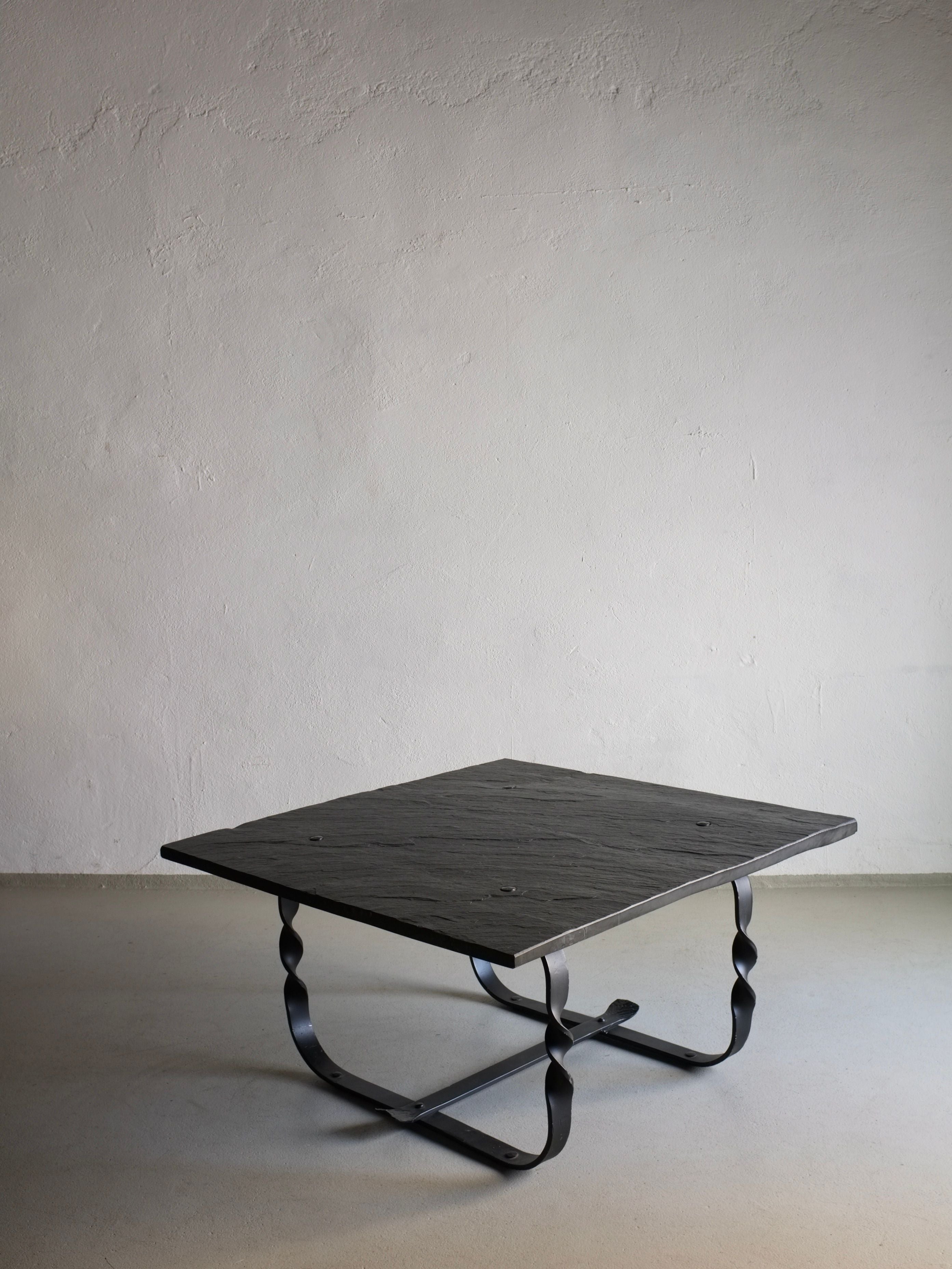 Brutalist coffee table with geometric steel base and reclaimed wood top