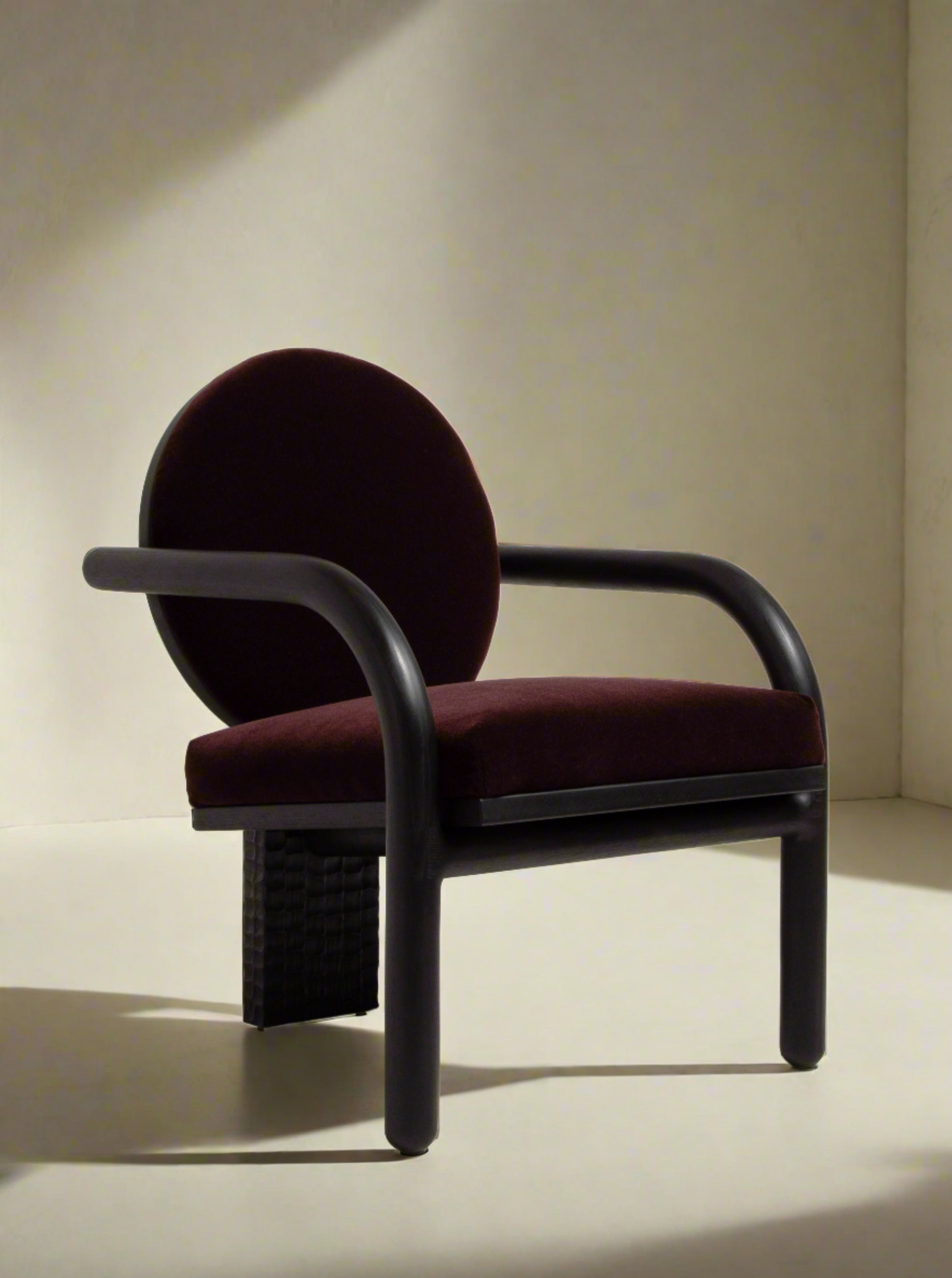 Theia Lounge Chair in sleek black leather with comfortable cushioning and modern design