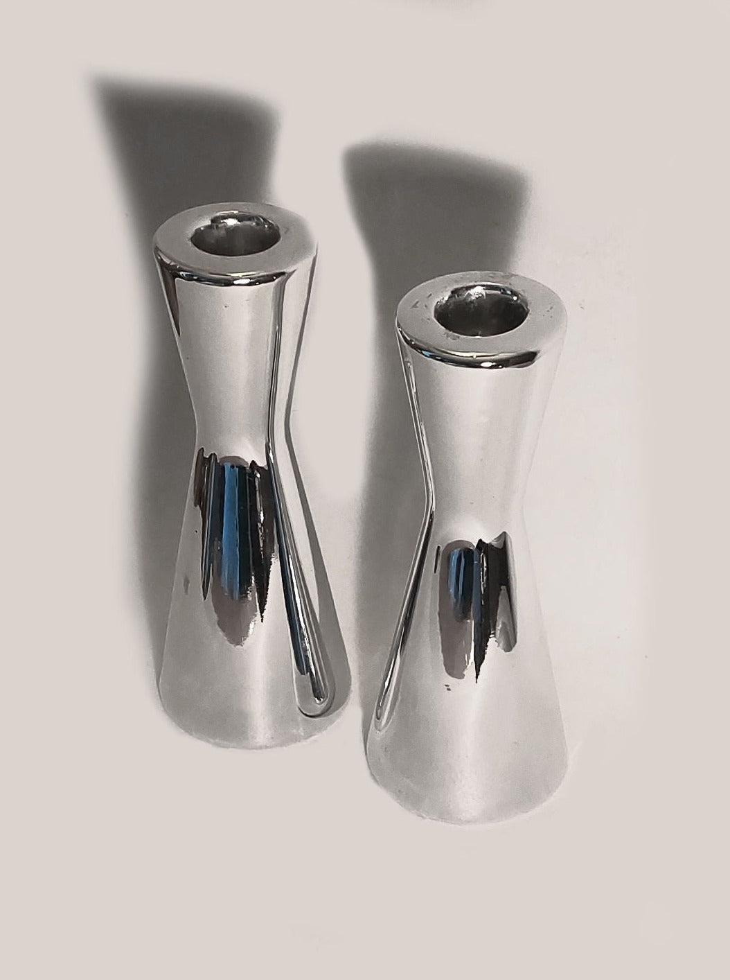 Set of 2 elegant ceramic silver candle holders on a table