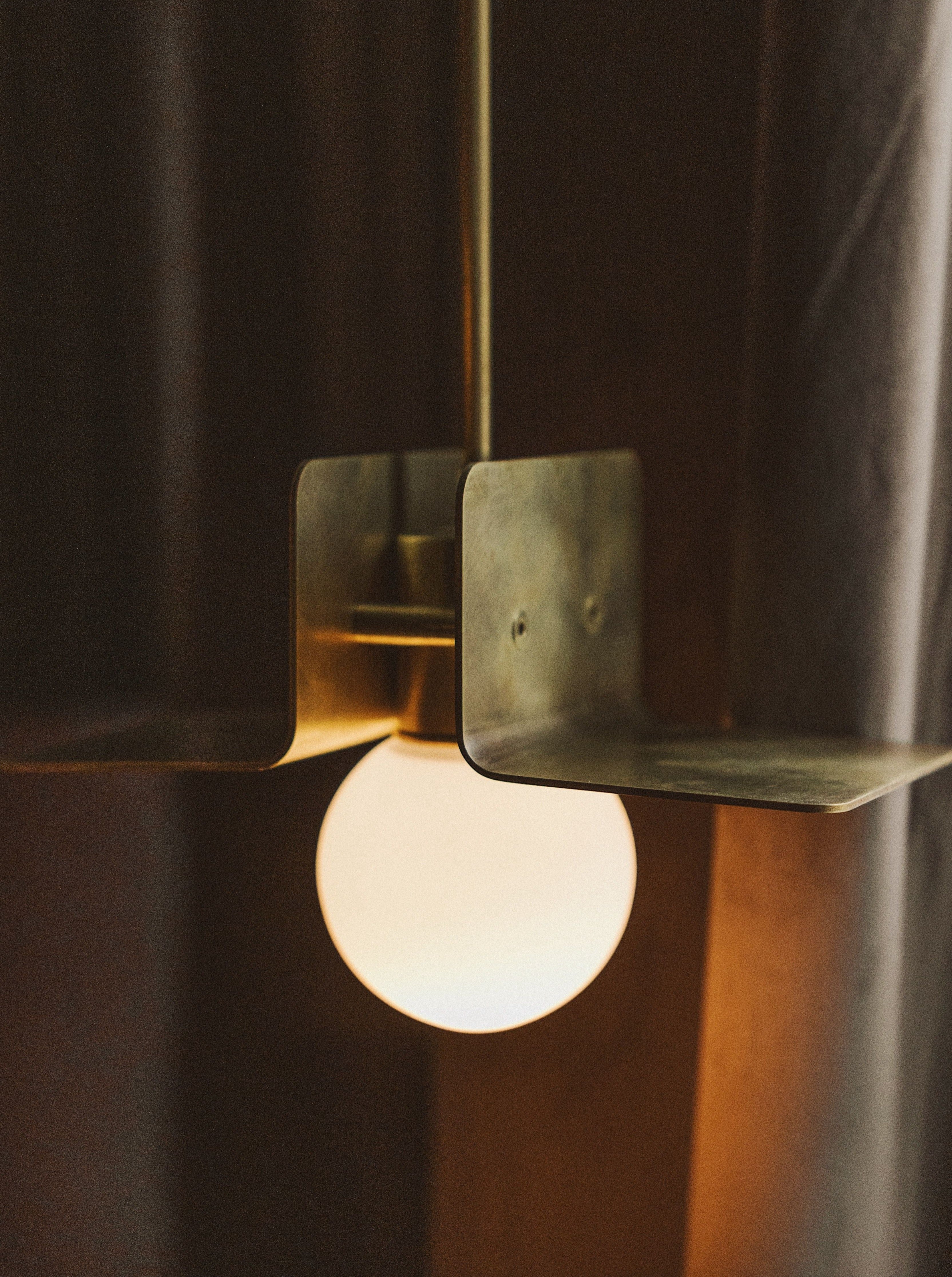 Luxurious silver lapel pendant featuring a sleek modern design with a striking sapphire centerpiece