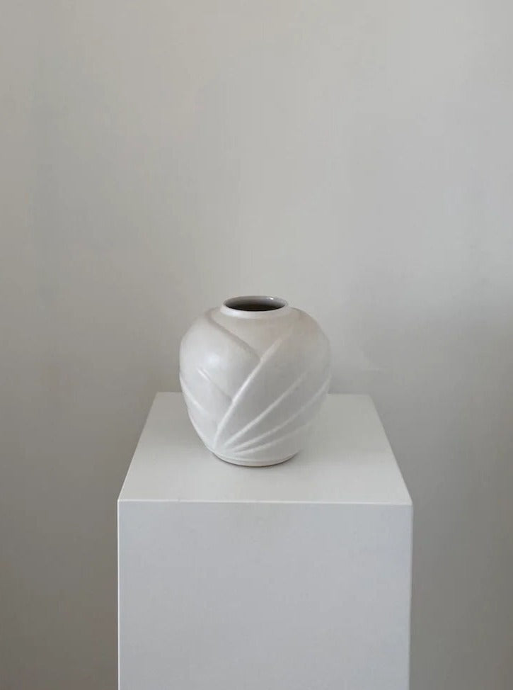 Handcrafted ceramic origami vase with intricate geometric folds and textured finish