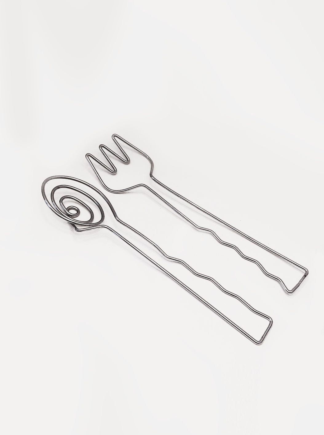 Stylish stainless steel salad servers with wooden handles for serving greens and vegetables at dinner parties or everyday meals