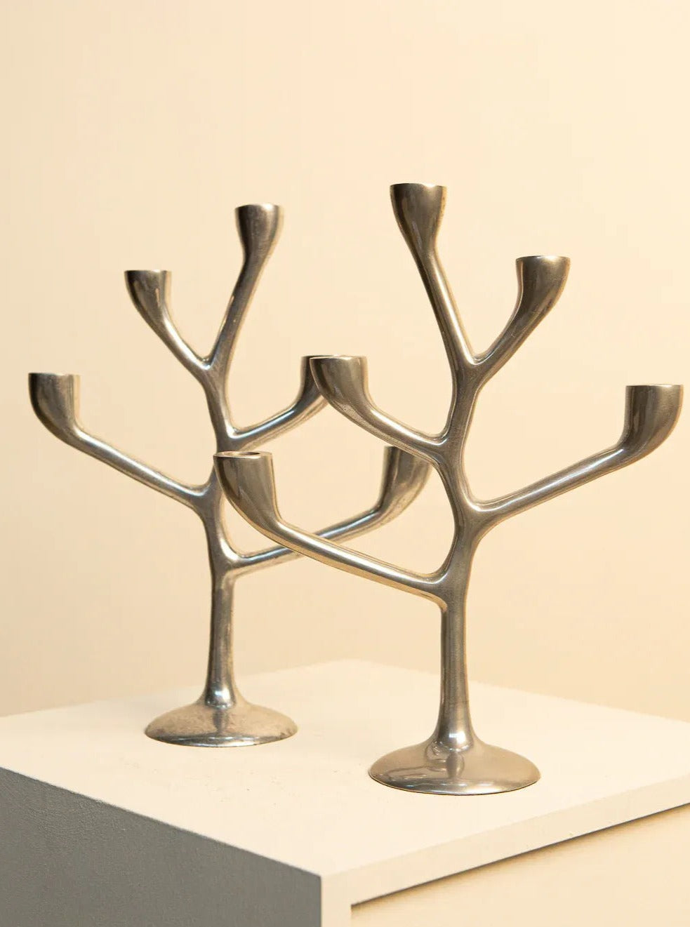A pair of Italian Arbre candleholders crafted from brass and marble