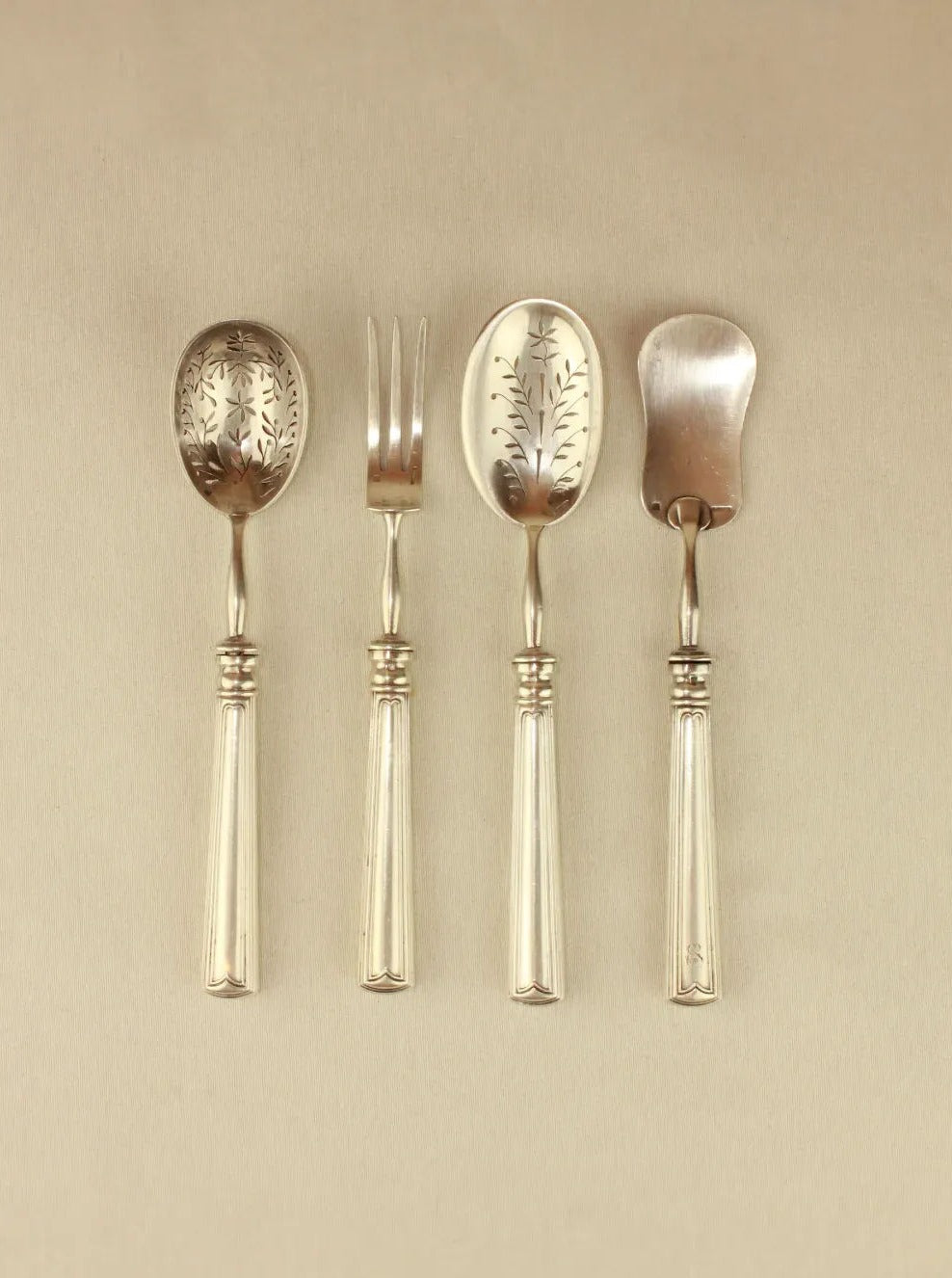 Set of silver-plated metal cutlery with intricate floral designs