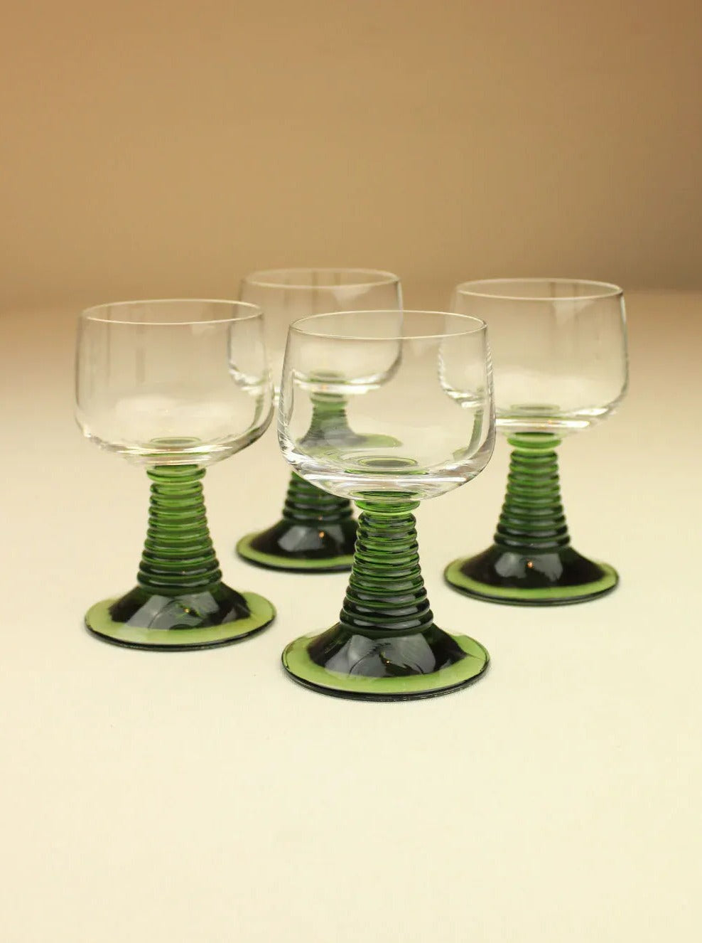 Set of four Roemer glasses with green stems and clear bowls