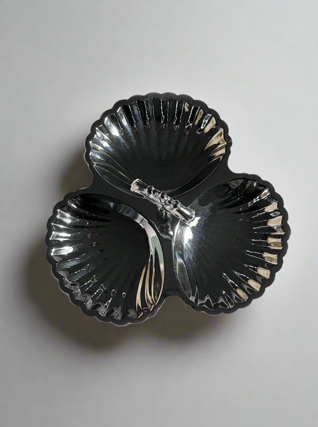 Three-tiered serving dish with white dishes and black frame