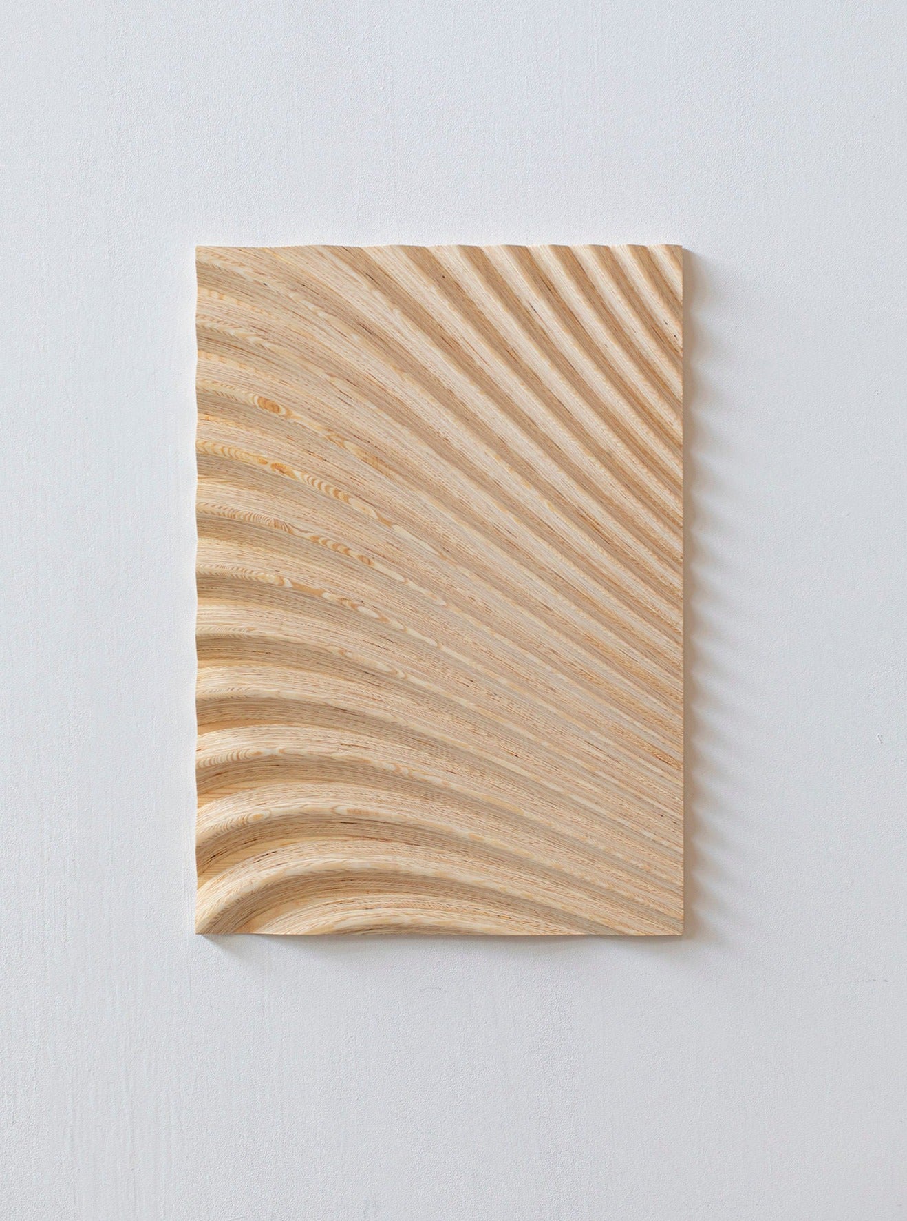 Wave Naturel by Studio Arno Hoogland is a handcrafted, light wood piece featuring smooth, wave-like grooves radiating from the lower left corner, creating an artistic ripple effect that embodies minimalist aesthetics, perfect for luxury interiors.
