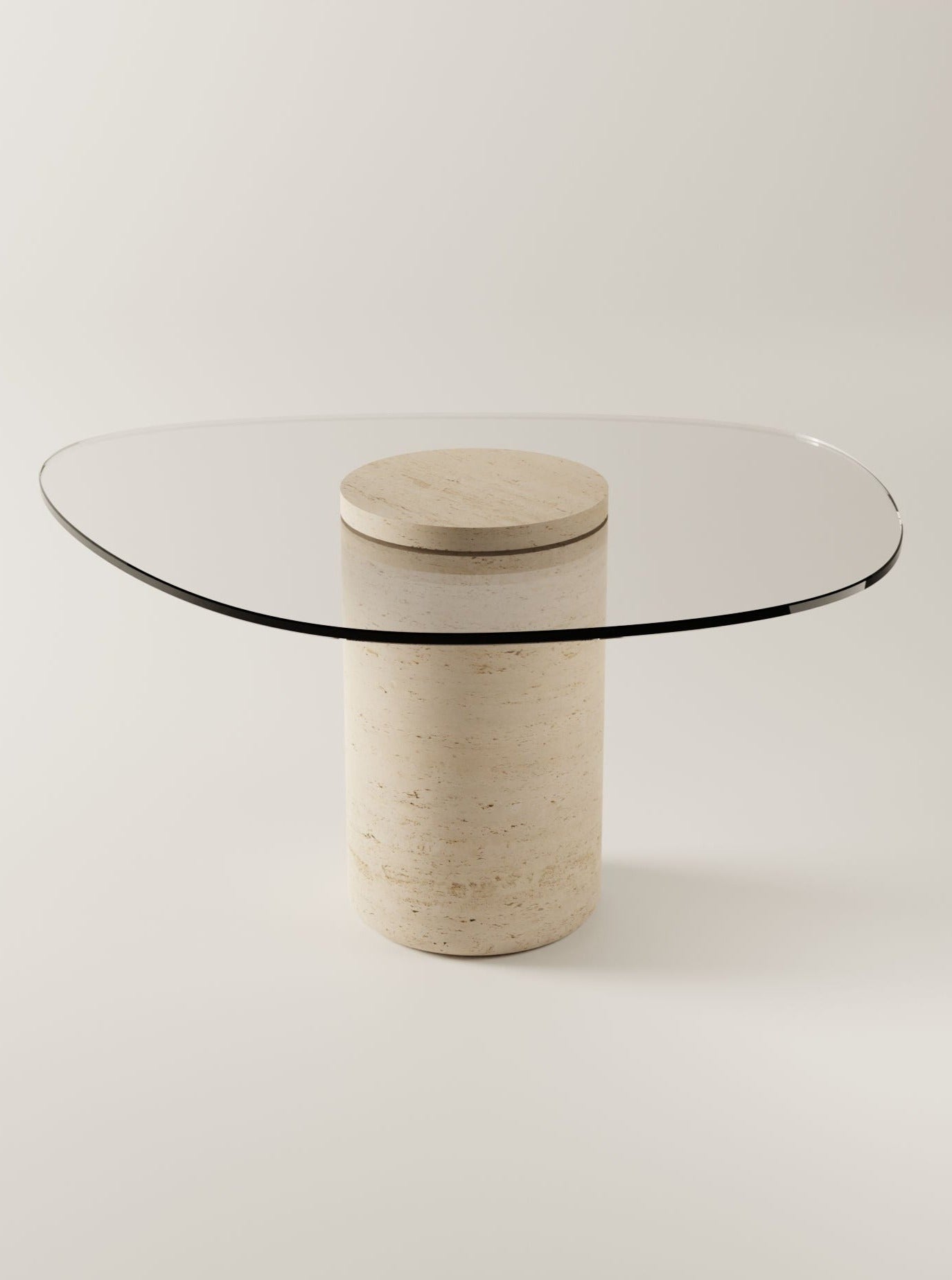 A modern UUfo 02 Dining Table by BURGIO featuring a round, travertine table top and a cylindrical, beige stone base, positioned against a plain, light-colored background.
