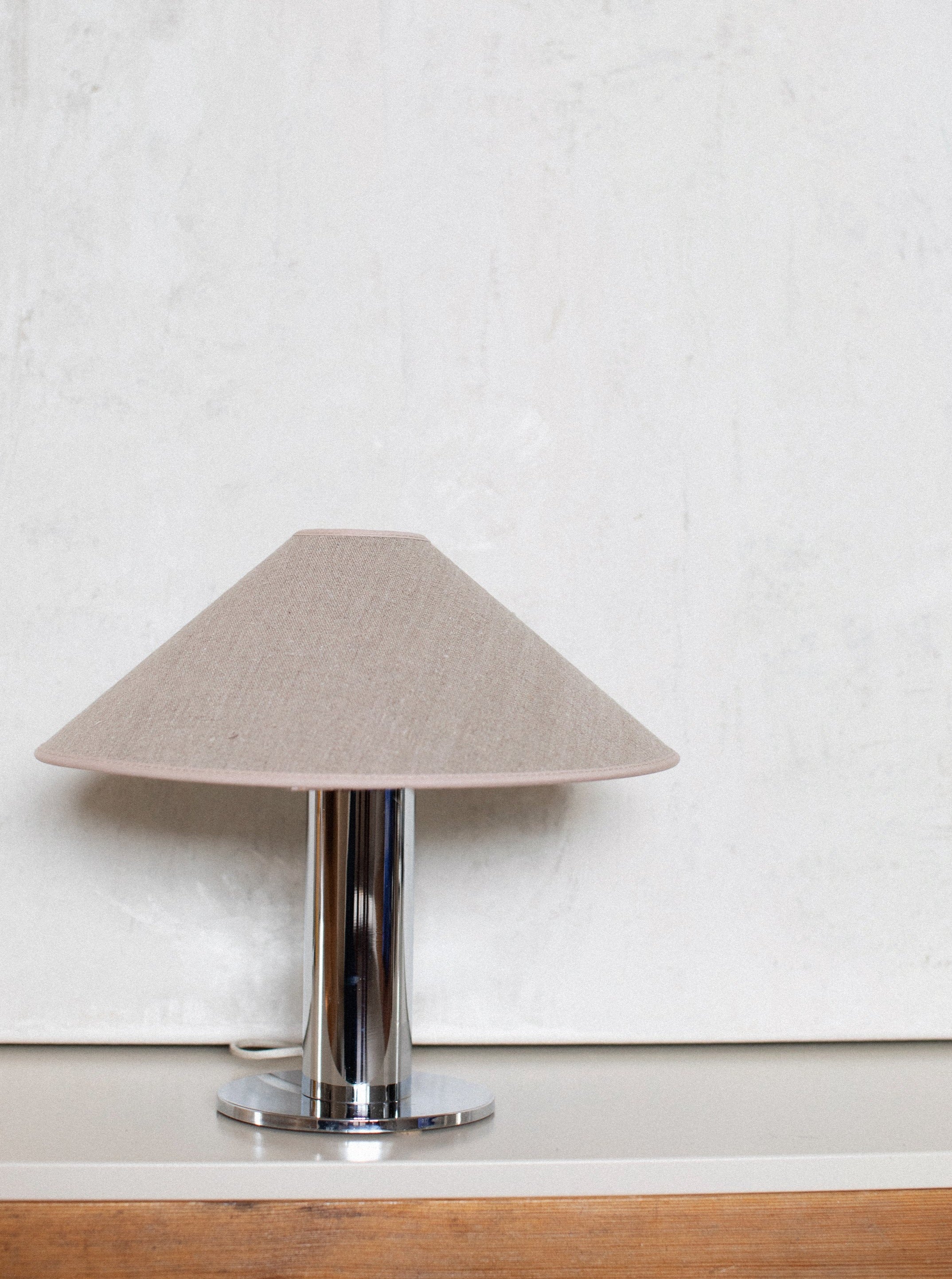 A modern Chrome Table Lamp with sleek design and adjustable arm