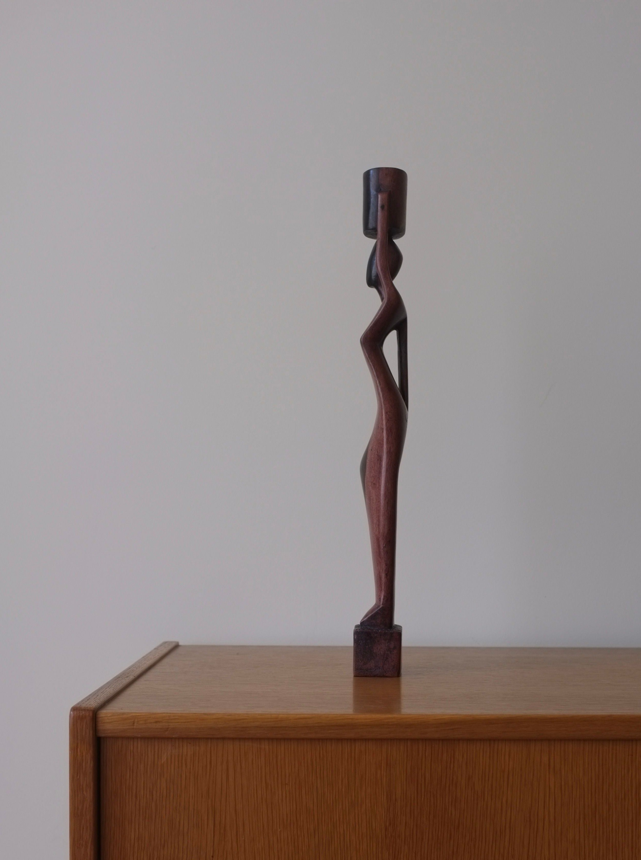 Carved-wood-female-candleholder-with-intricate-detailing-and-ornate-design