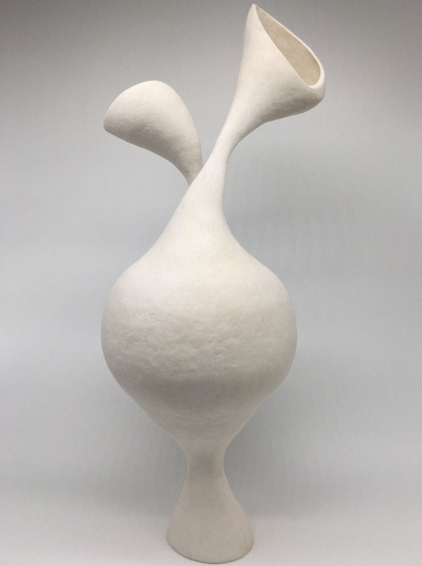 The Swans product standing on a clear glass surface, reflecting light and elegance