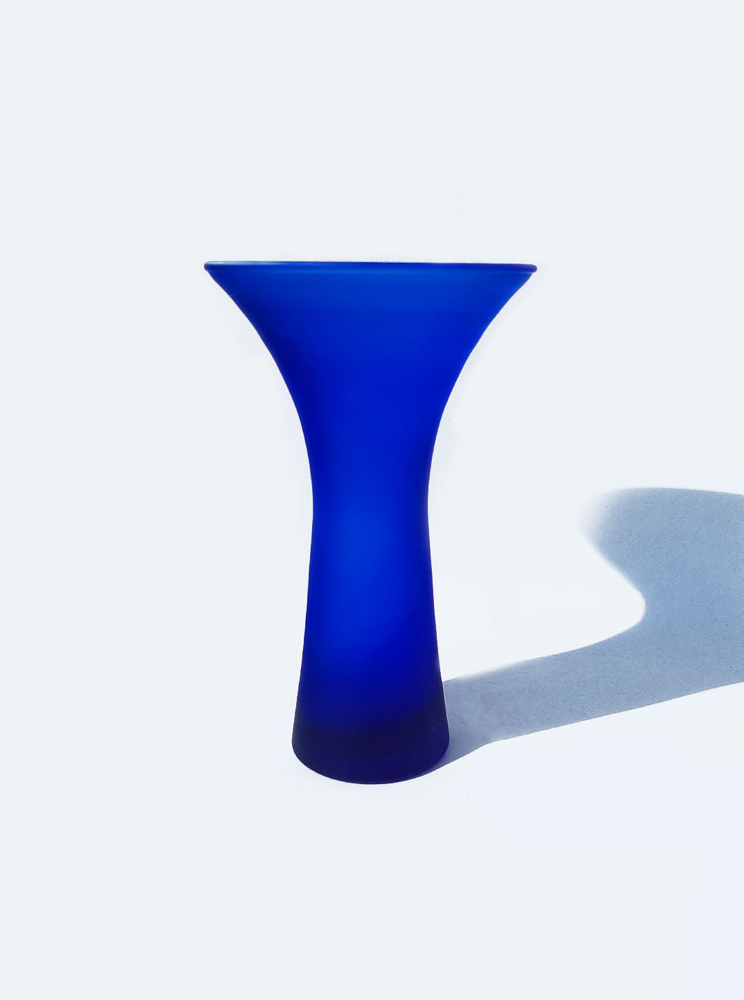 Beautiful deep blue ceramic vase with intricate hand-painted design and glossy finish