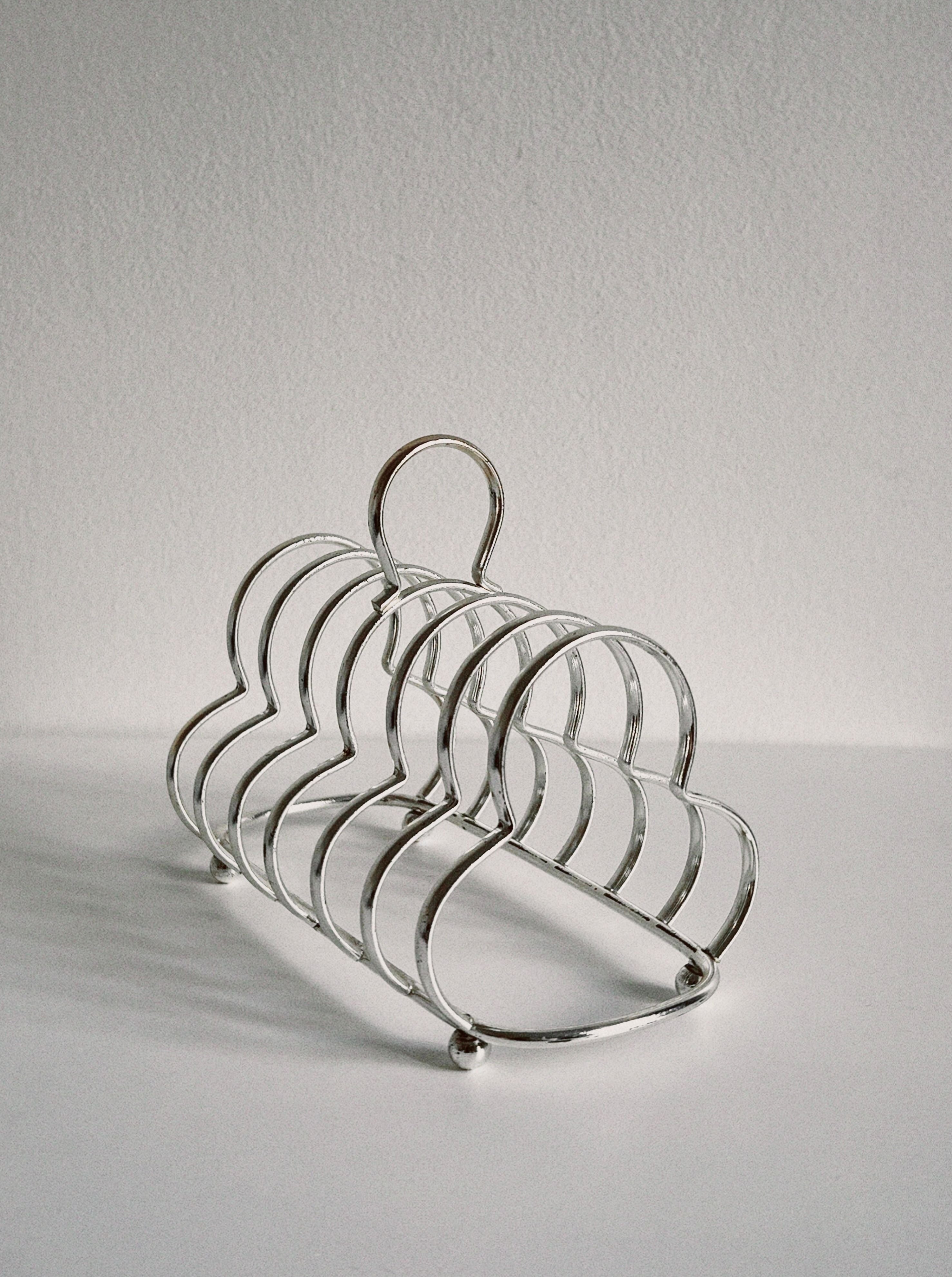 Club shaped toast holder made of stainless steel for serving breakfast