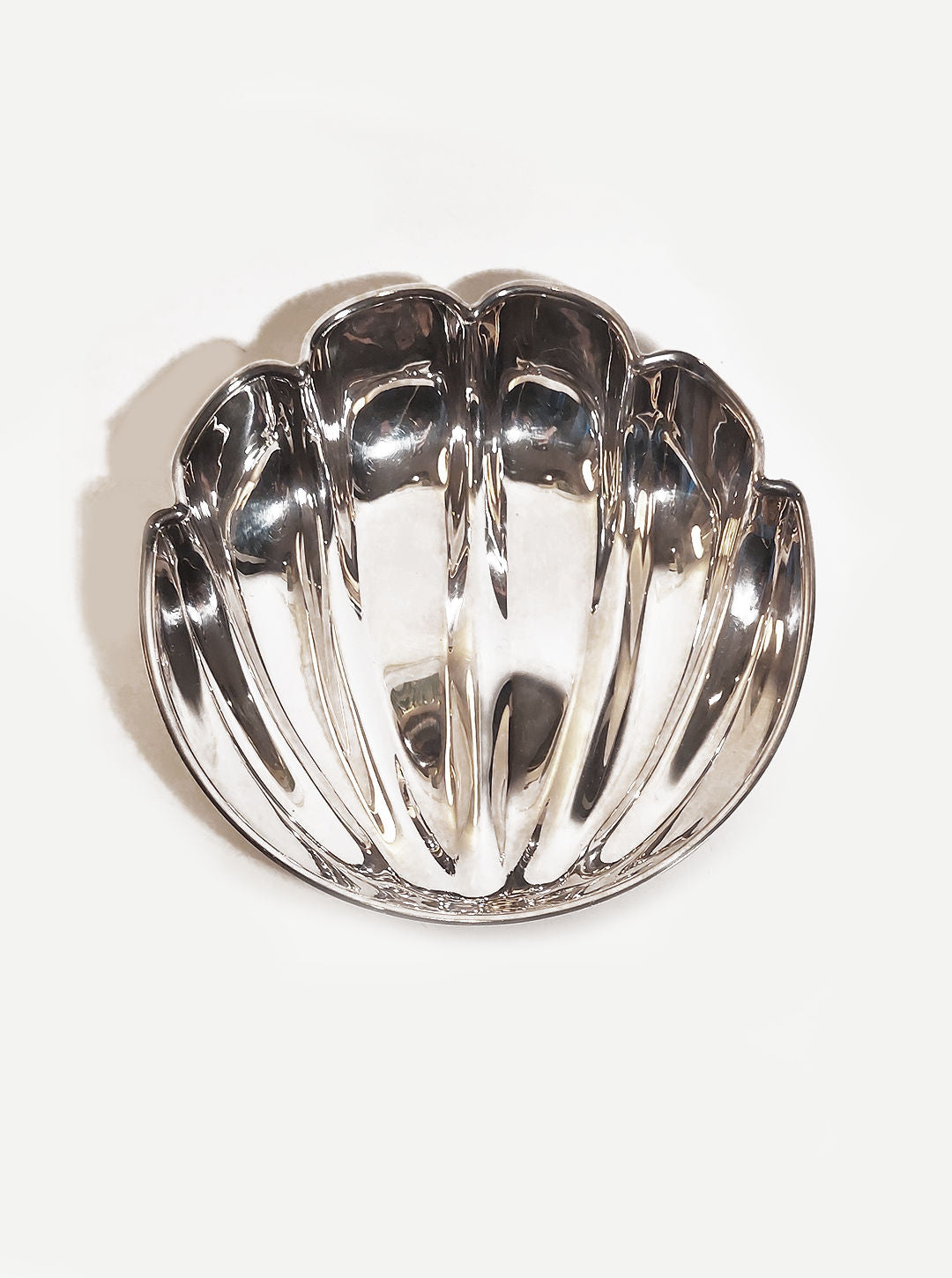 Beautiful handcrafted medium shell dish made of durable ceramic material with intricate details and a glossy finish