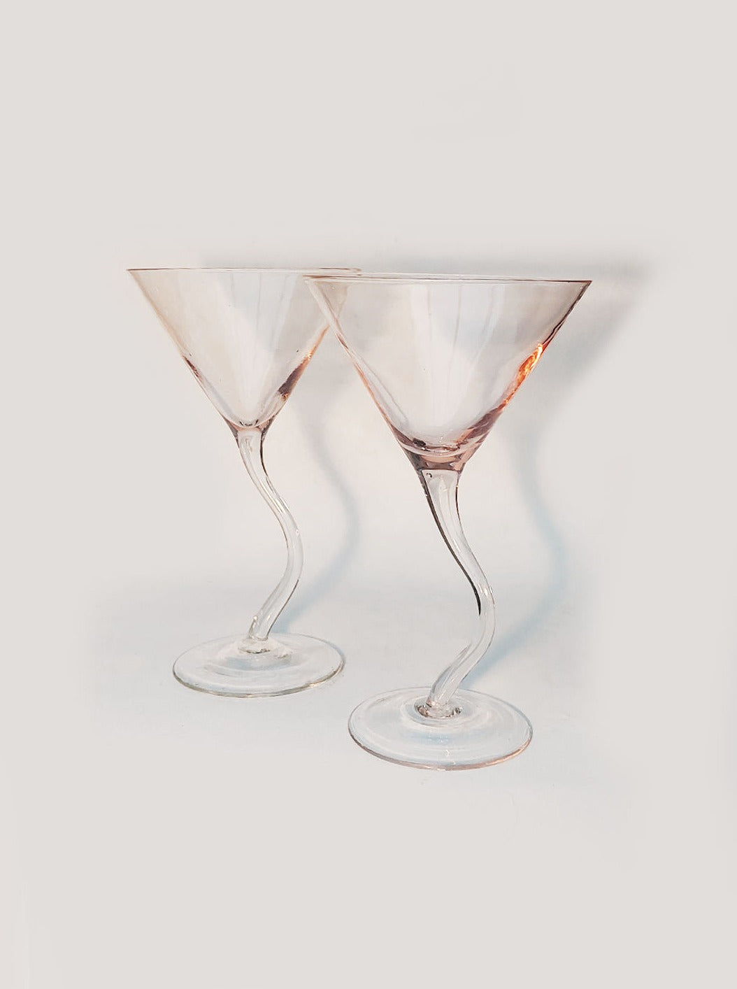 Duo of elegant wavy cocktail glasses with twisted design and smooth rim