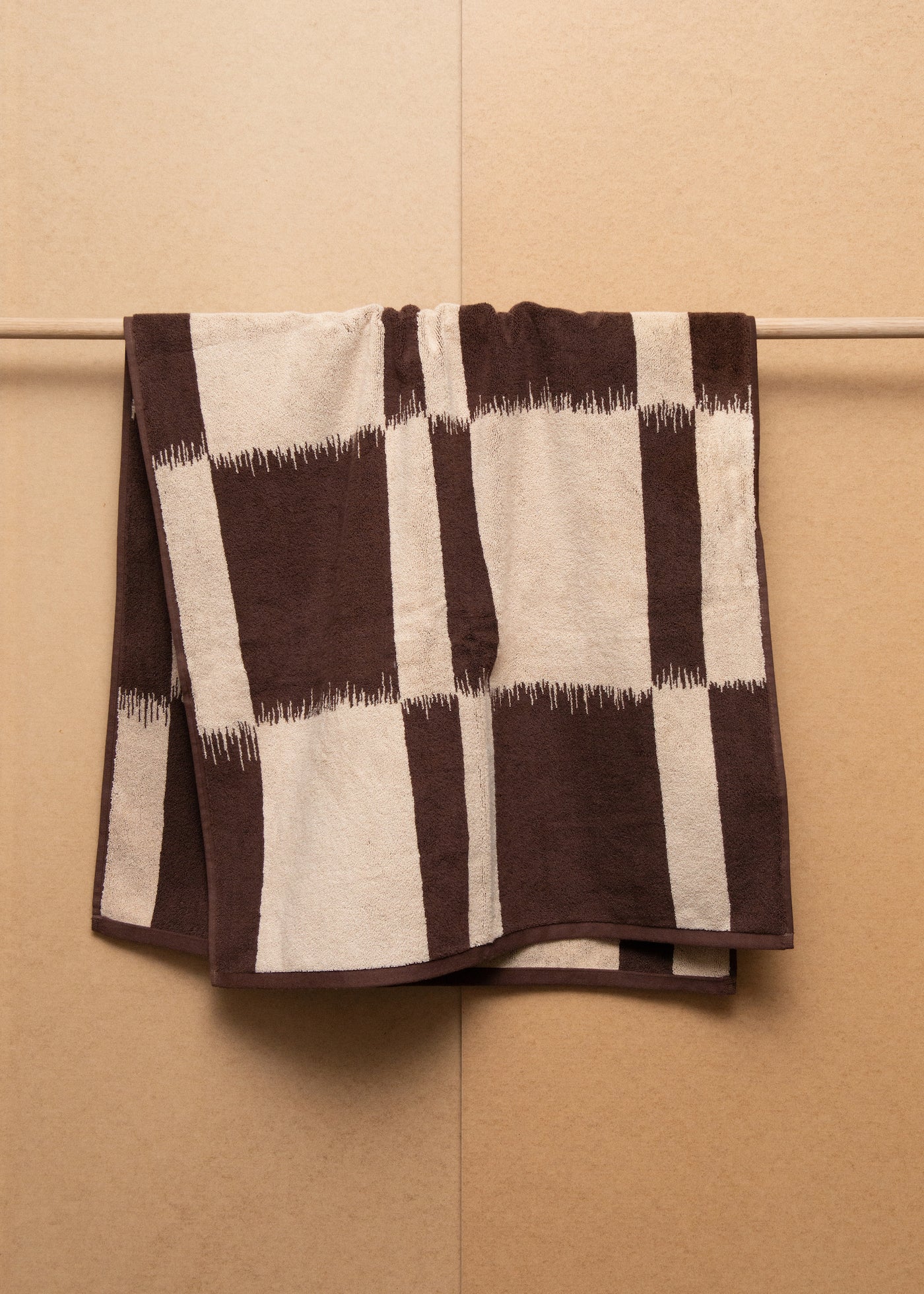 A brown and beige checkered Towel designs for bathroom