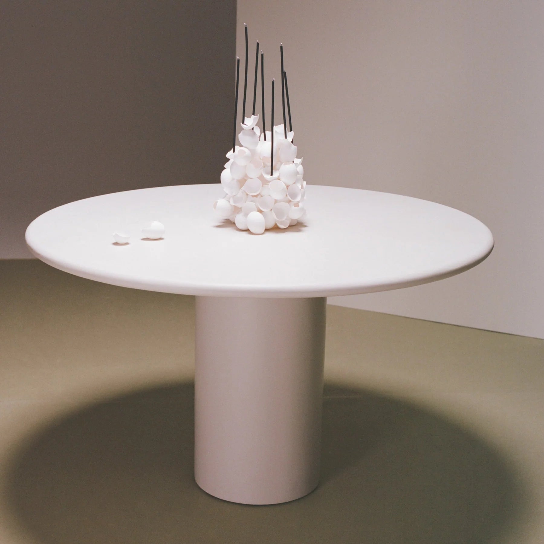 Gio Dining Table — round white table in minimalist setting