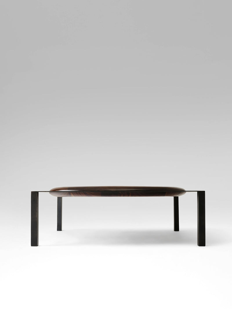 Split coffee table with dark wood oval top and black metal legs