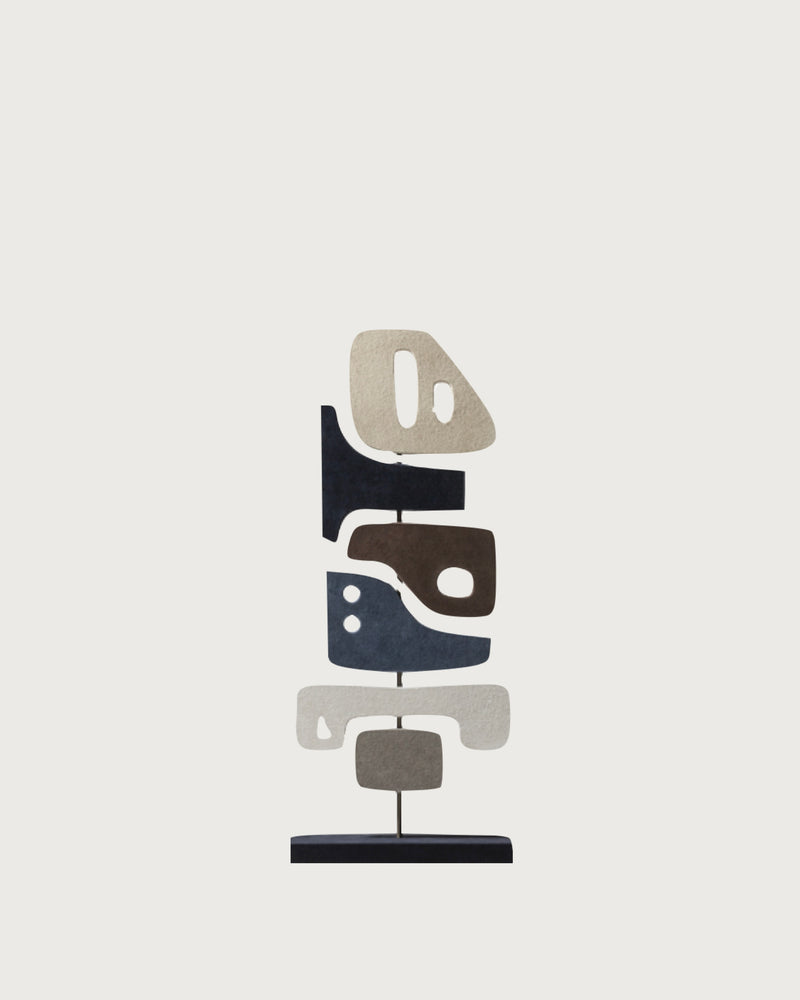 Modern abstract sculpture with stacked geometric forms in neutral tones