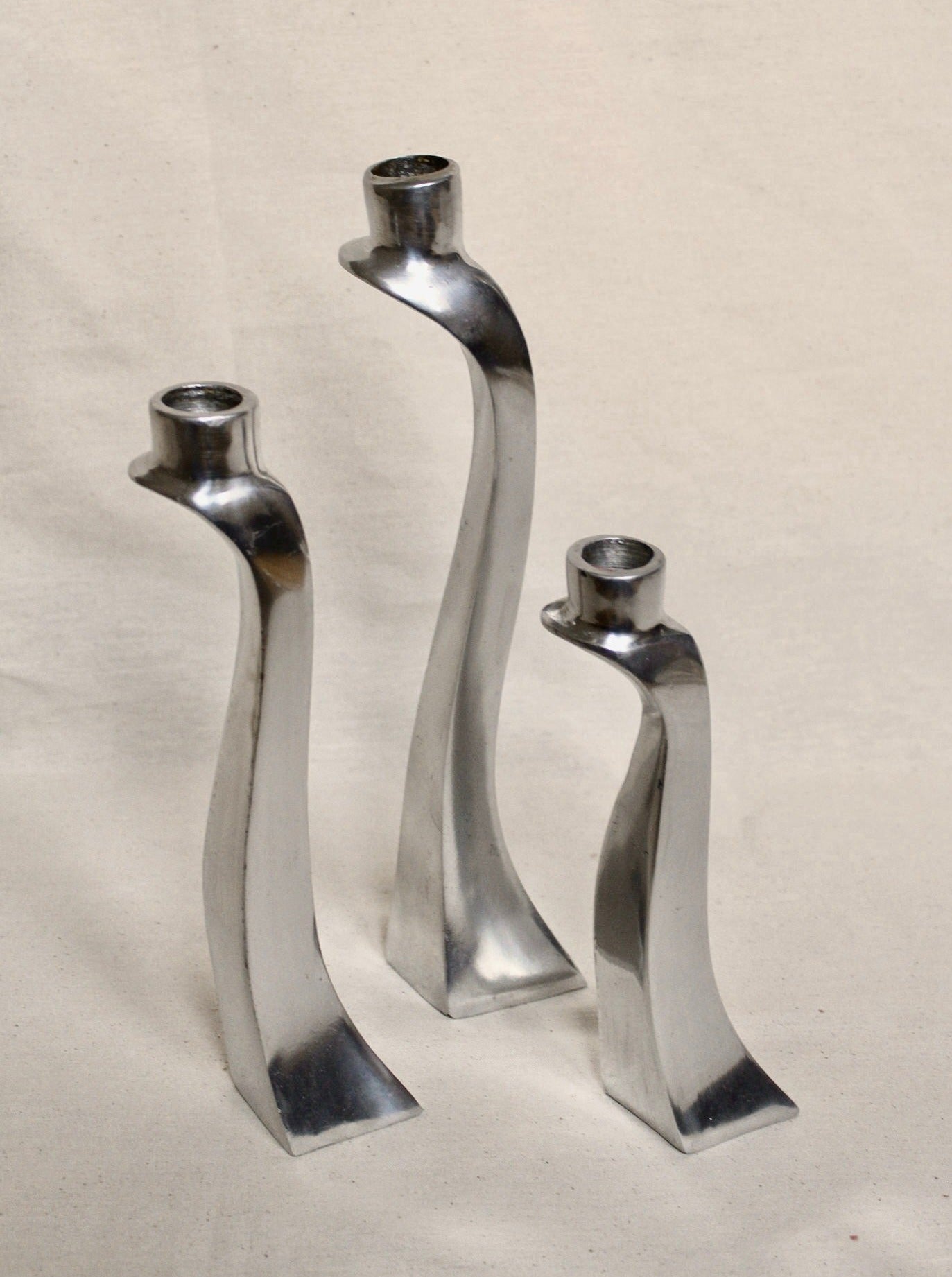 Three elegant and modern cobra-shaped candleholders in a set