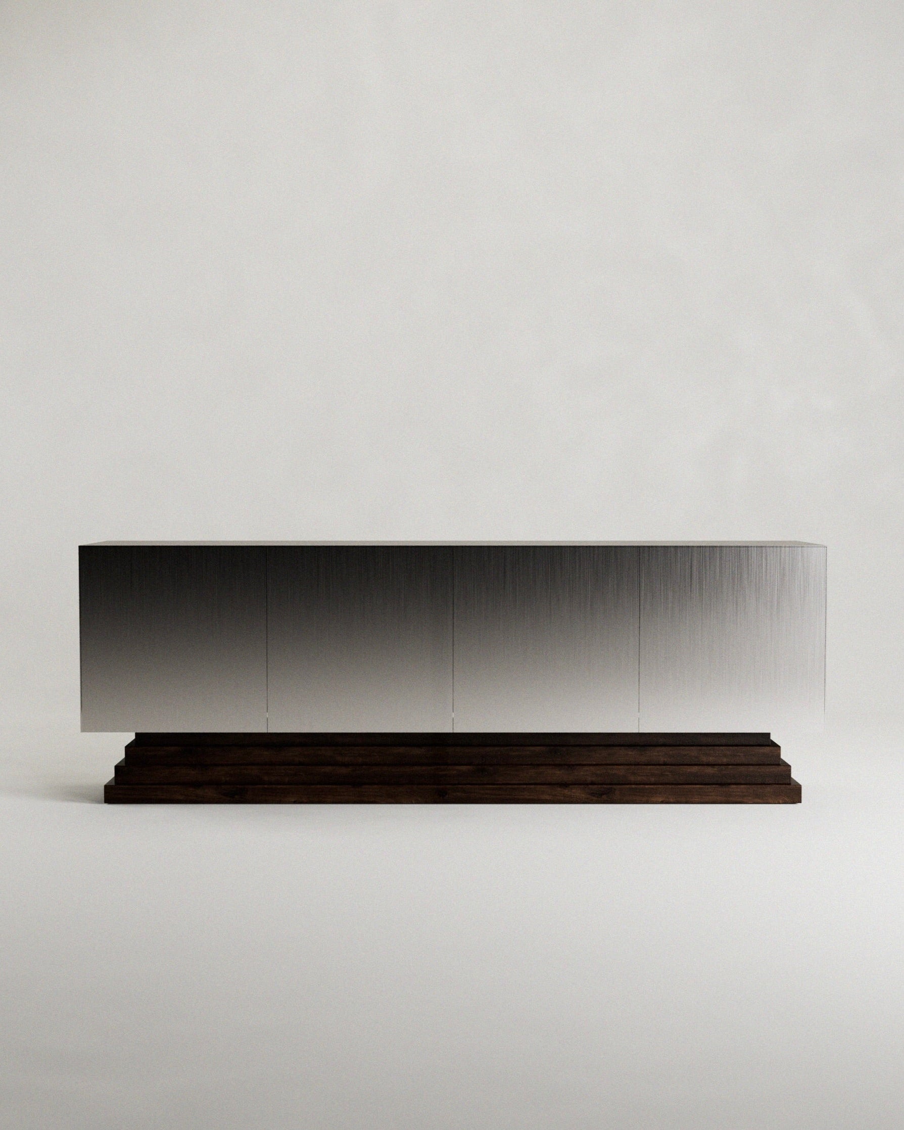 The 'Fragua' Sideboard by Siete Studio features a sleek modern design with a metallic brushed surface atop a dark tiered walnut base, showcasing minimalist design and artisanal craftsmanship against a plain white background.