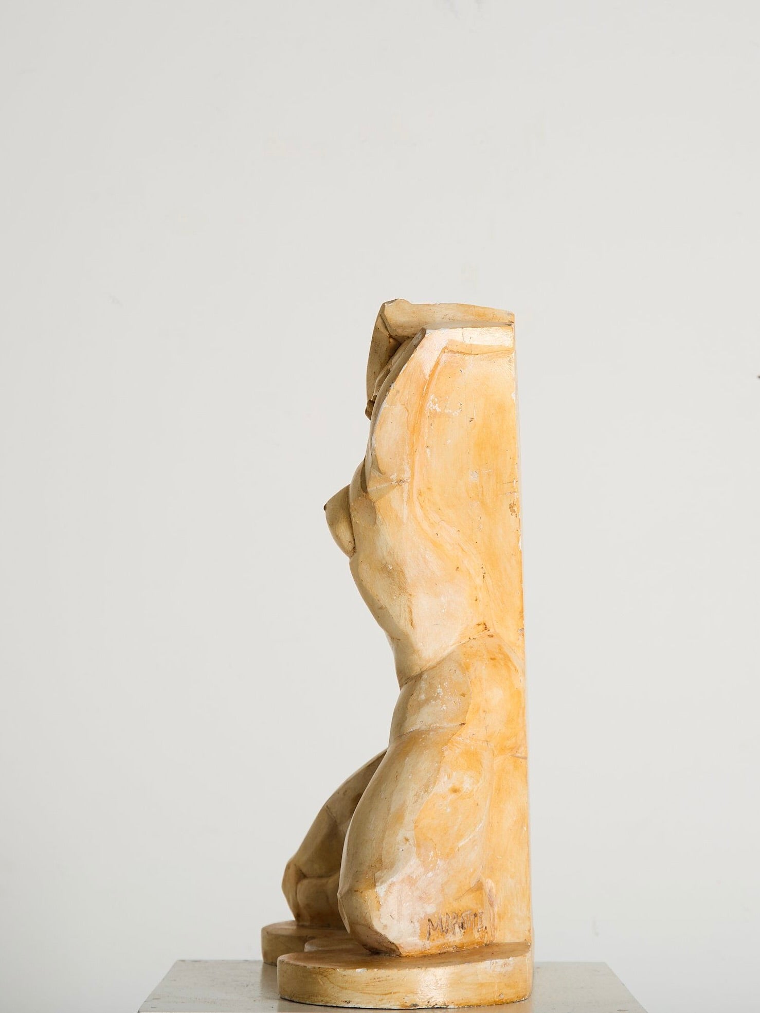 A side view of Ancien et Jolie's "Cubist Plaster Study" shows an abstract, cubist-inspired sculpture. Its graceful form and pale finish echo the minimalist aesthetics of 1960s France, set against a plain white backdrop.