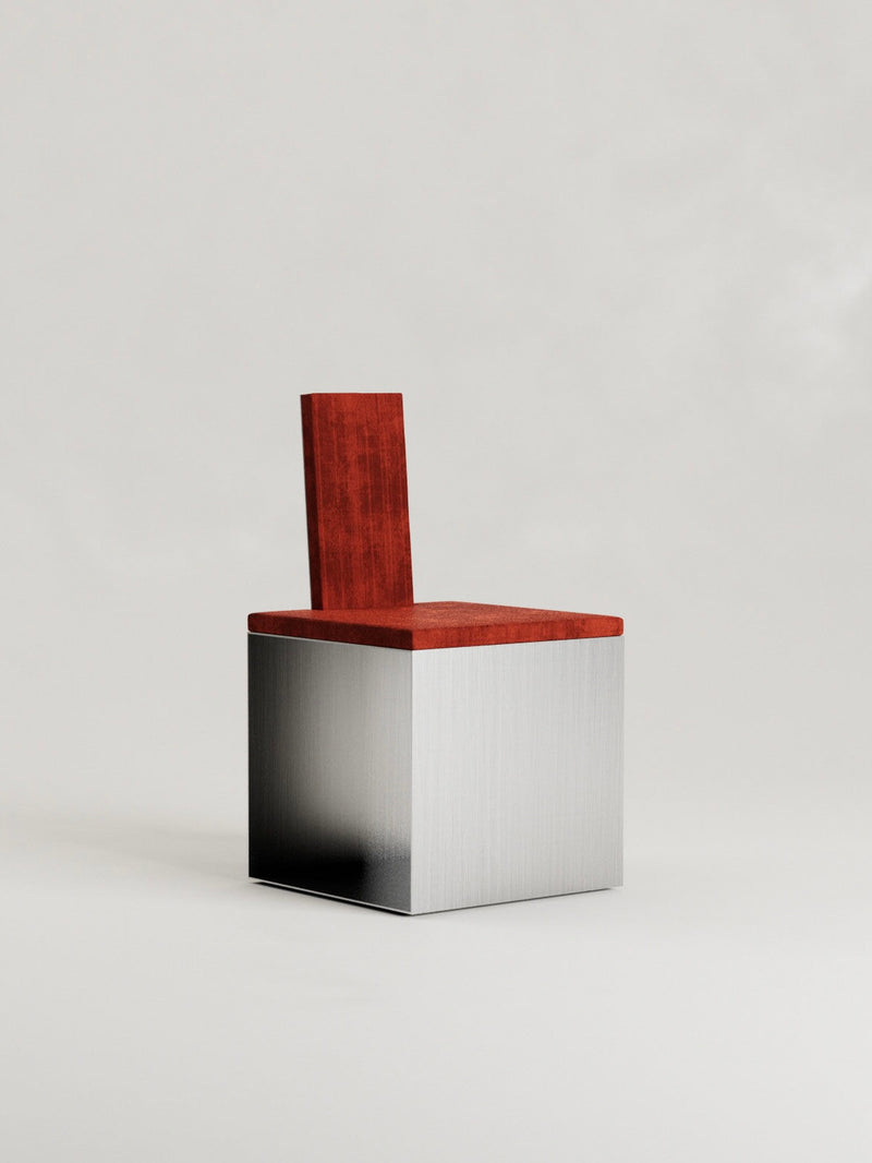 The 'Fragua' Chair by Siete Studio features a geometric design with a metallic cube base and warm-toned wooden seat and backrest. Its brushed metal texture complements the polished wood, making it a perfect minimalist piece against a light gray background, embodying metallurgical craftsmanship.