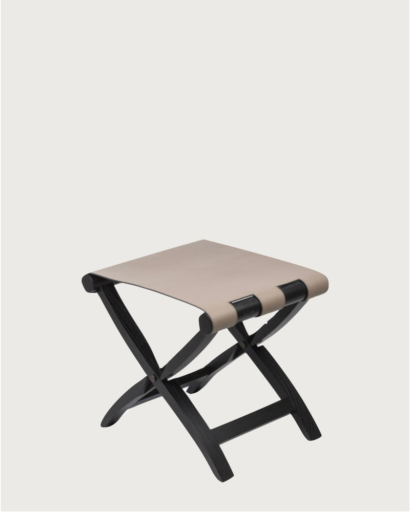 Arturo folding stool with beige leather seat and black wood frame