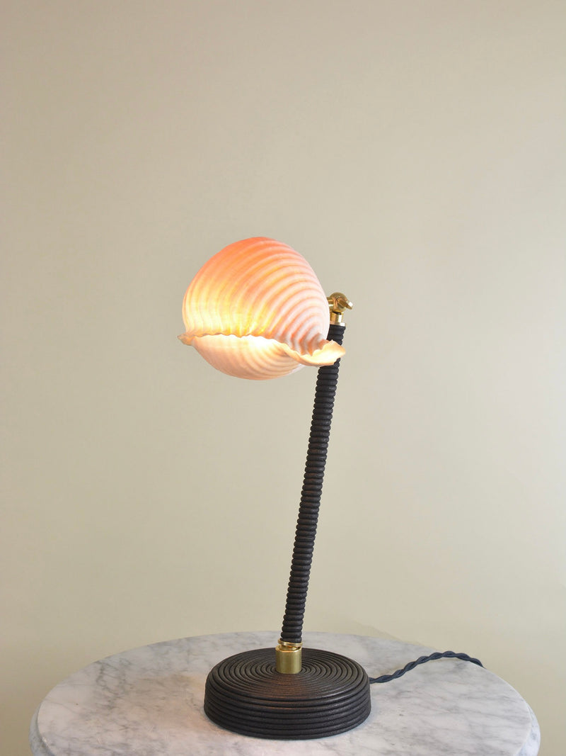 L'Escargot table lamp with ribbed glass shade on marble surface