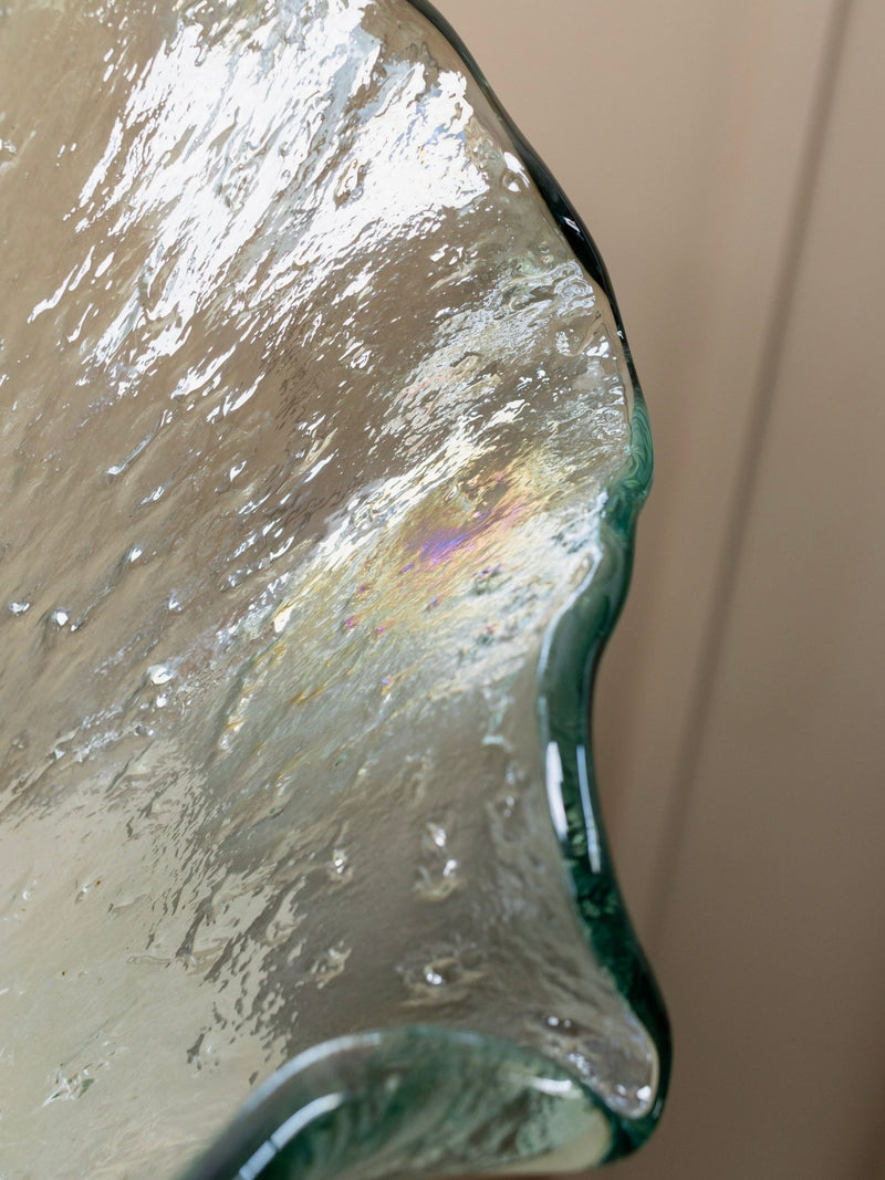 Close-up of a Solid Vintage Murero Glass Vase by Bottega Jacobs, showcasing an abstract translucent design with a textured surface and iridescent sheen, reminiscent of 1970s Italian style. The vase features fluid, wavy edges and subtle color variations against a soft, neutral background.