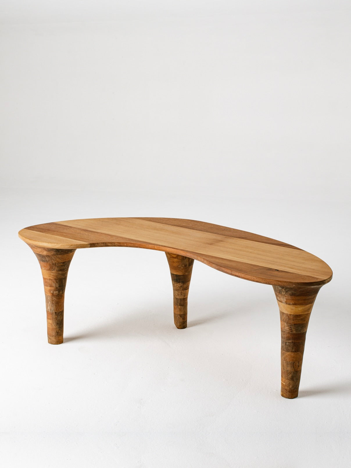Curved organic wood coffee table with sculptural tapered legs