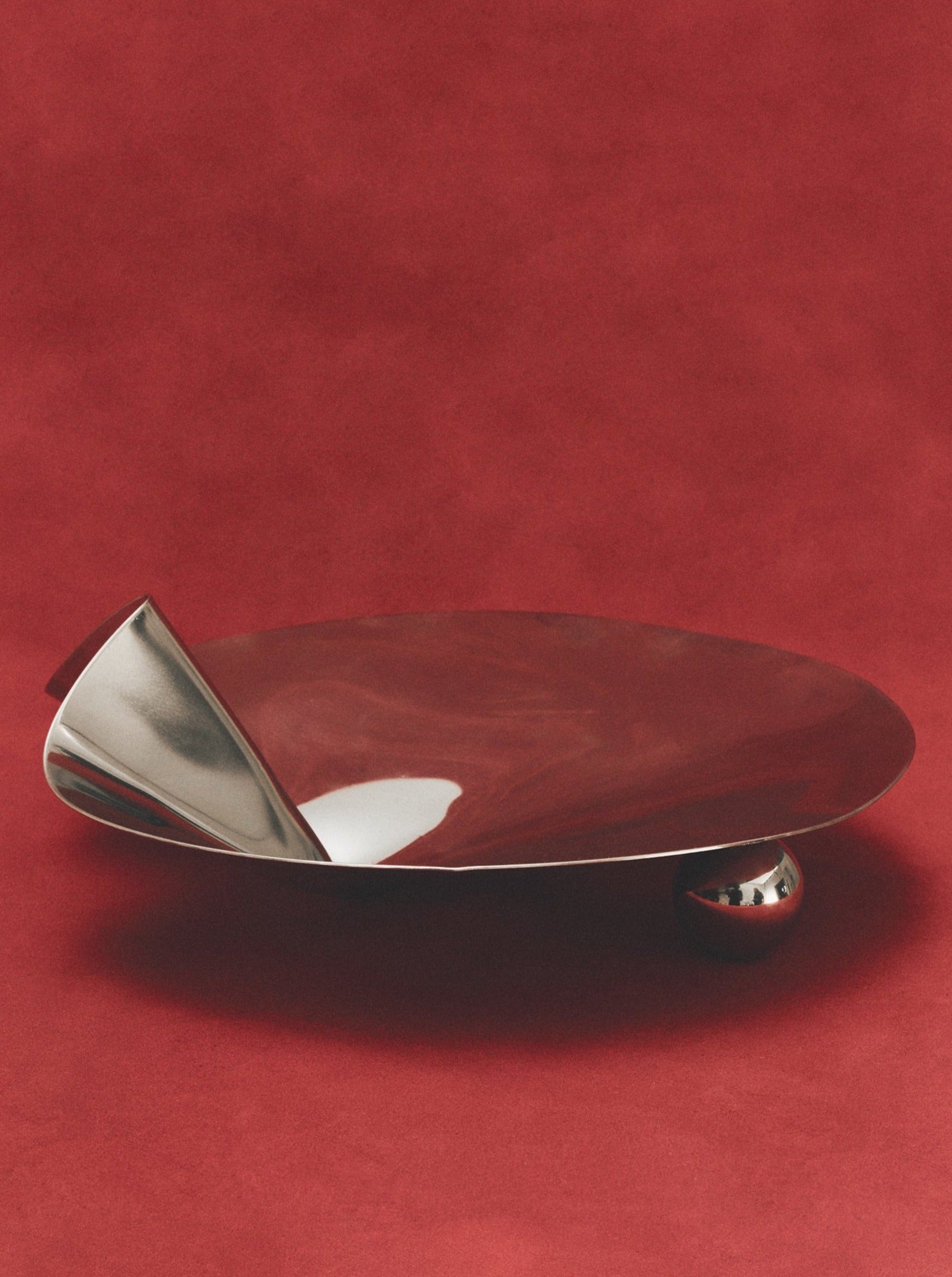 Stainless steel footed serving bowl with decorative rim and polished finish