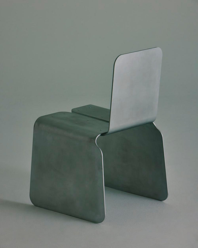 The LESORR Rounded Edges Chair features a sleek brushed aluminum design with curved edges, blending modern style and durability.