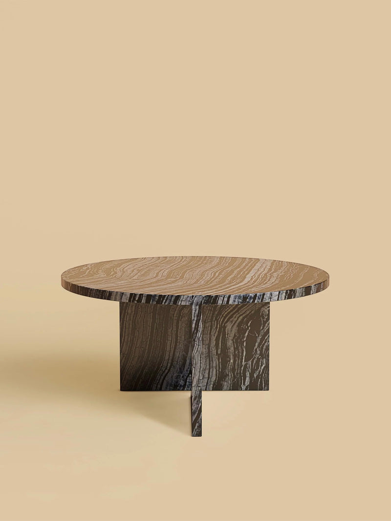 The "Hashi" Coffee Table in Marble by Lebanto features a modern circular design with a thick round top and unique geometric base. It showcases a sleek marble texture with natural brown and gray patterns on a beige background, enhancing any room's decor elegantly.