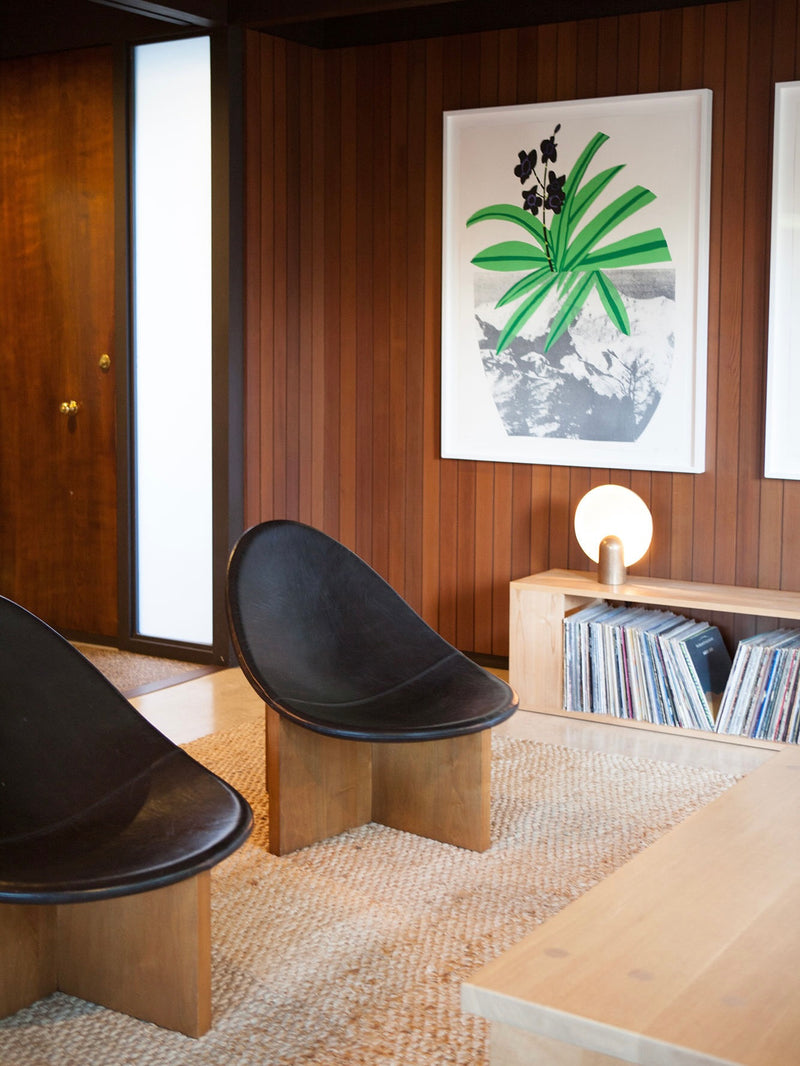 Black leather Nido lounge chairs in mid-century modern interior
