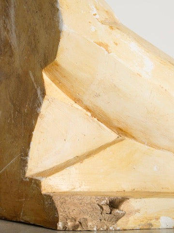 Close-up of the Cubist Plaster Study by Ancien et Jolie, featuring a beige sculpted corner with geometric shapes and texture variations. Minor cracks and roughness lend a handcrafted look. The lighting evokes 1960s French art studios, highlighting details and shadows.