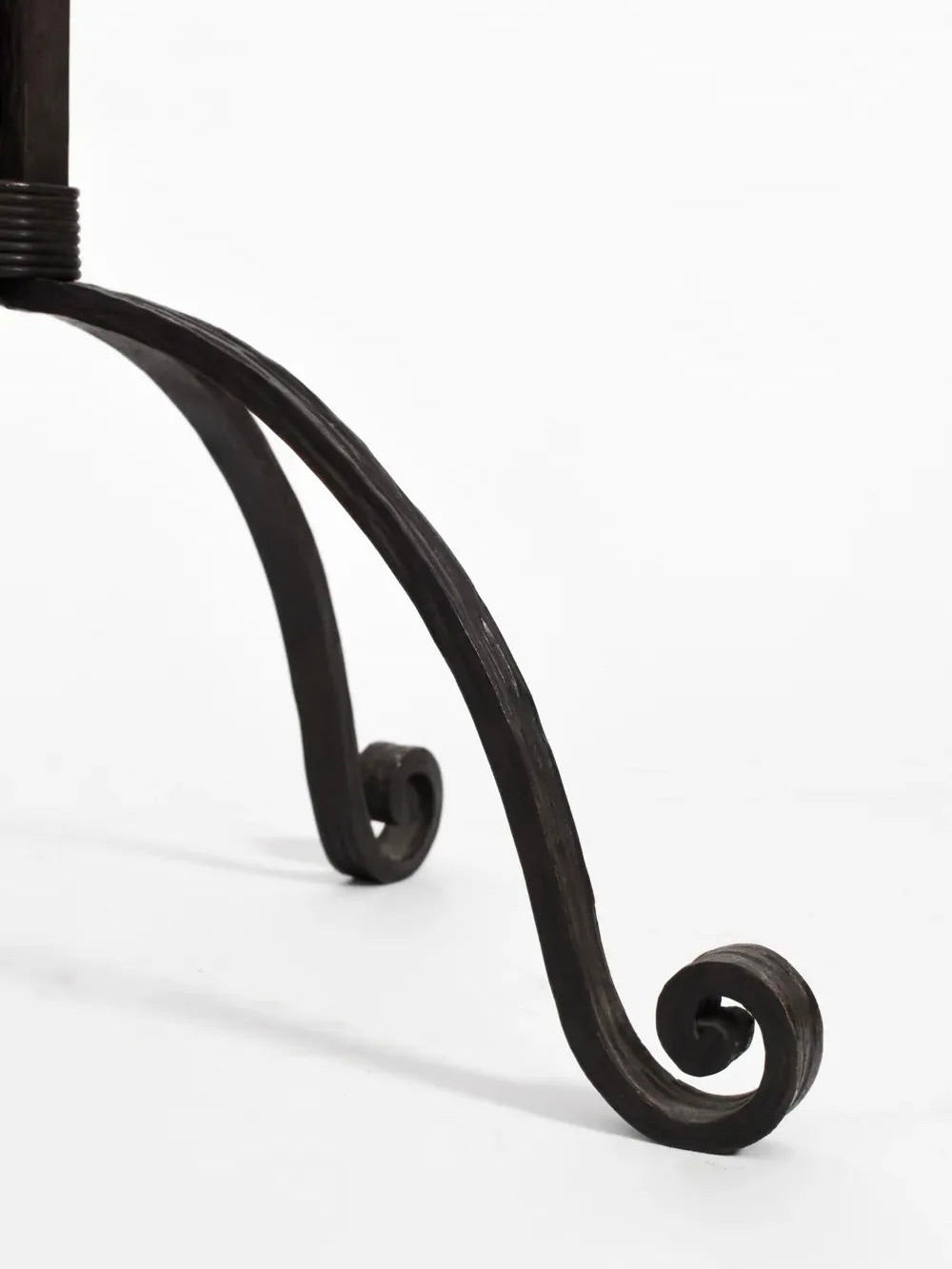 Close-up of an ornate, black metal leg of the Barracuda Interiors Arts Deco Iron Floor Lamp from the 1930s, featuring elegant, curled designs at the bottom against a plain white background, echoing an Art Deco style.