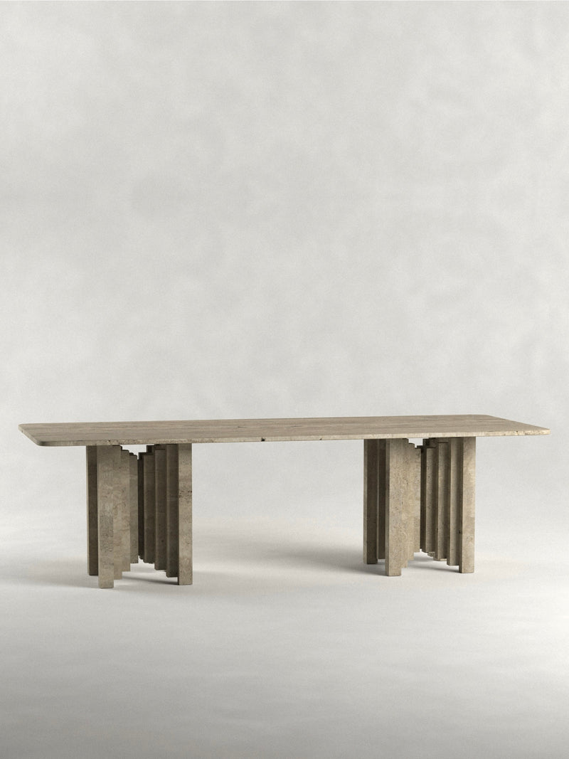 The "Calakmul" Dining Table S1 by Siete Studio is a long, rectangular wooden piece with a geometric pillar base at both ends, set against a plain light gray background. Expertly handcrafted, it showcases timeless elegance and craftsmanship.