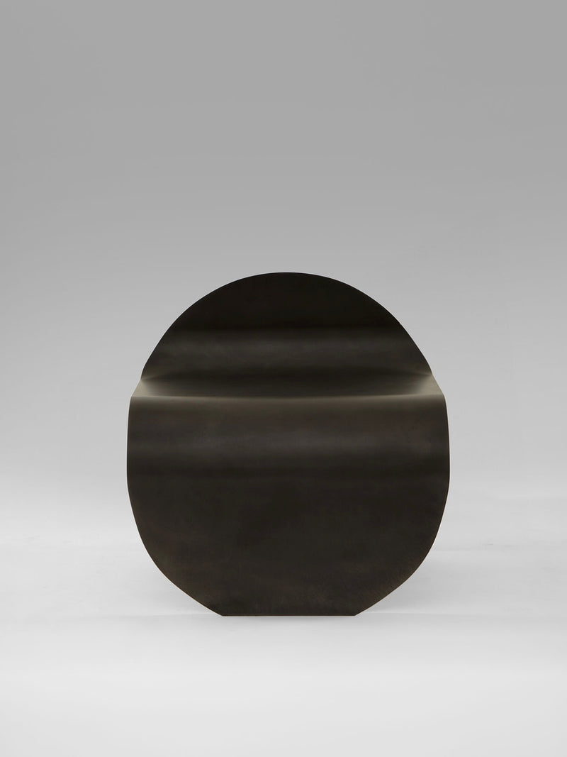 Dark wood O Stool by Estudio Persona with curved organic form